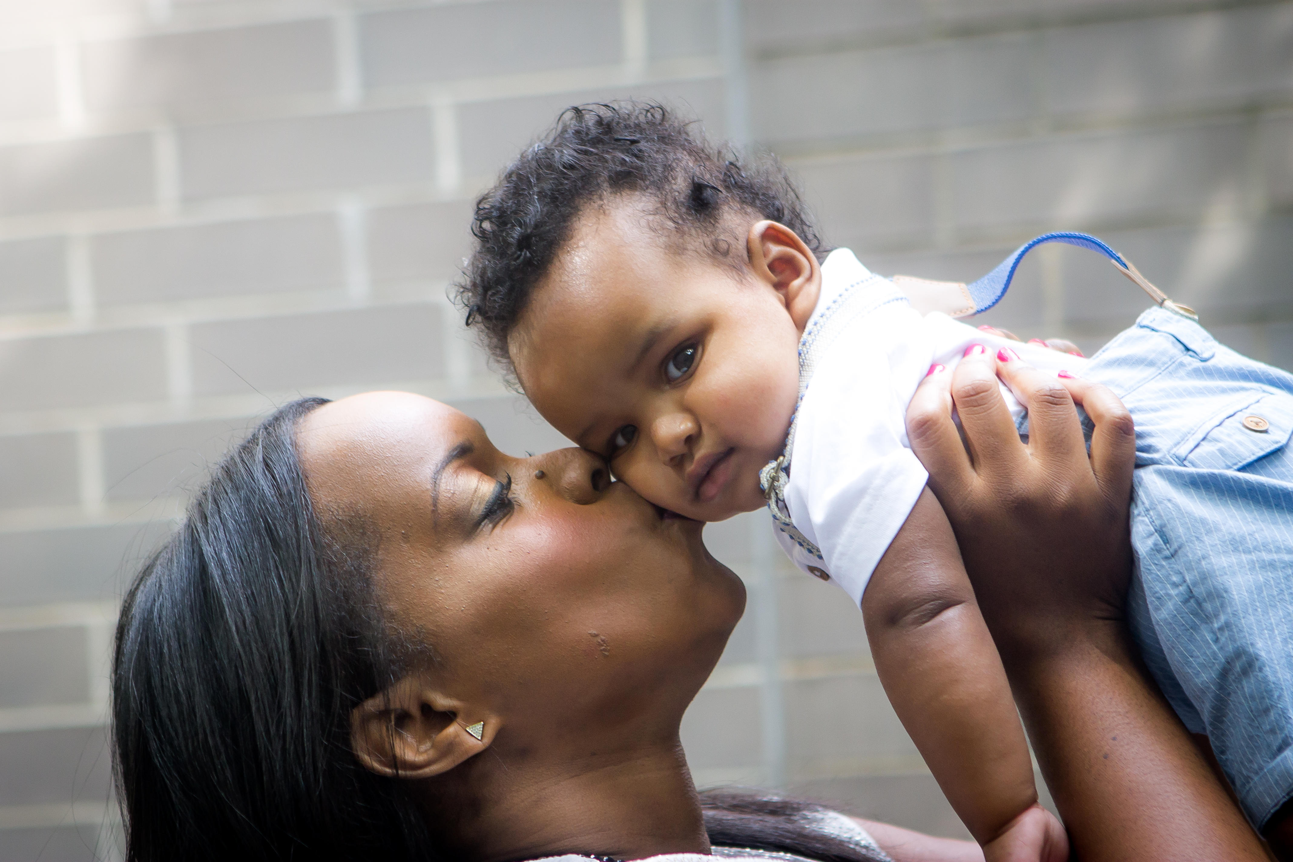 Mother kissing her baby