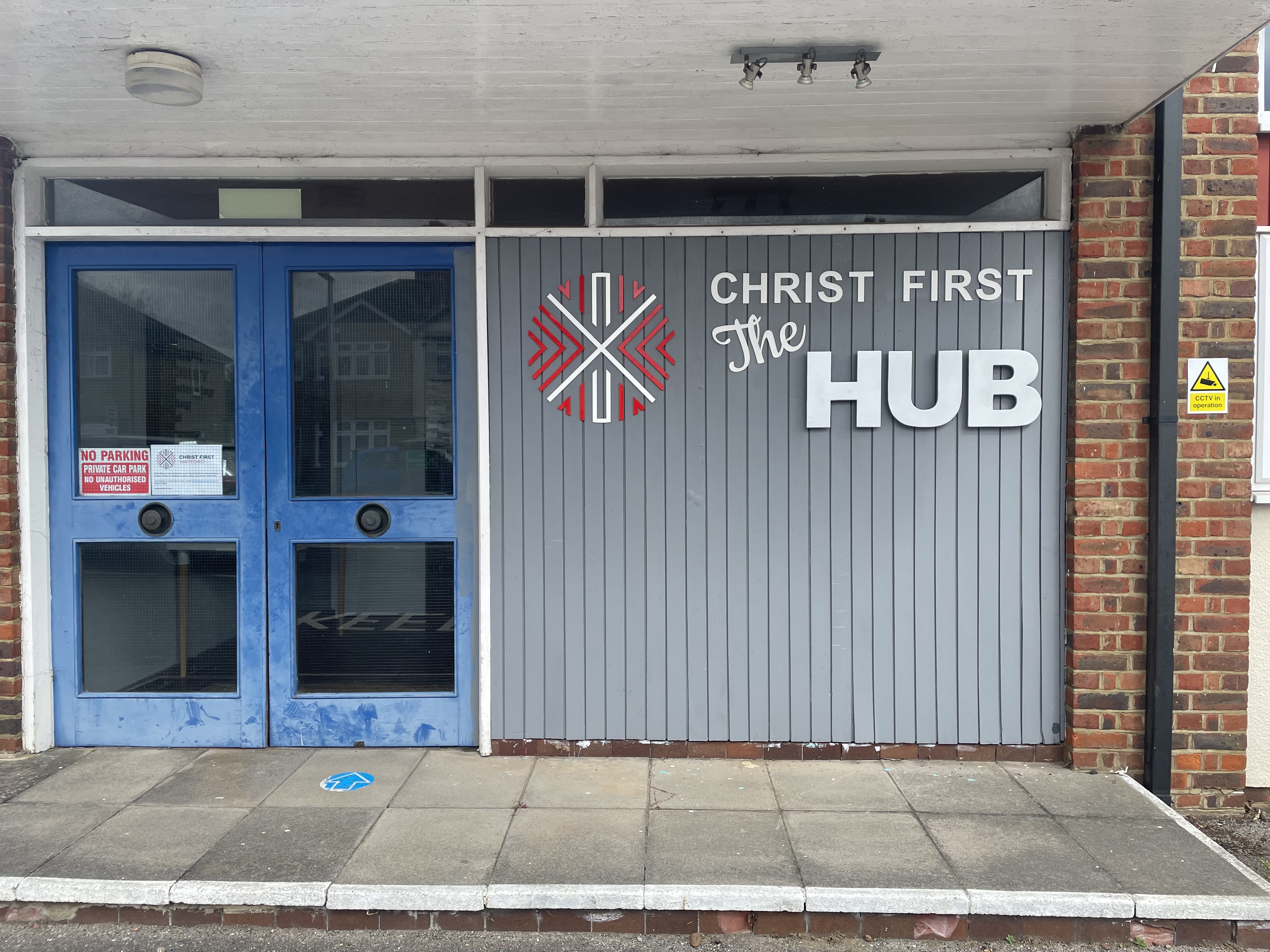 Christ First Hub where X1 Church sometimes carry out activities to help Afghan refugees feel like part of the community, The hub has blue doors and a grey sign which reads: 'Christ First The Hub'.