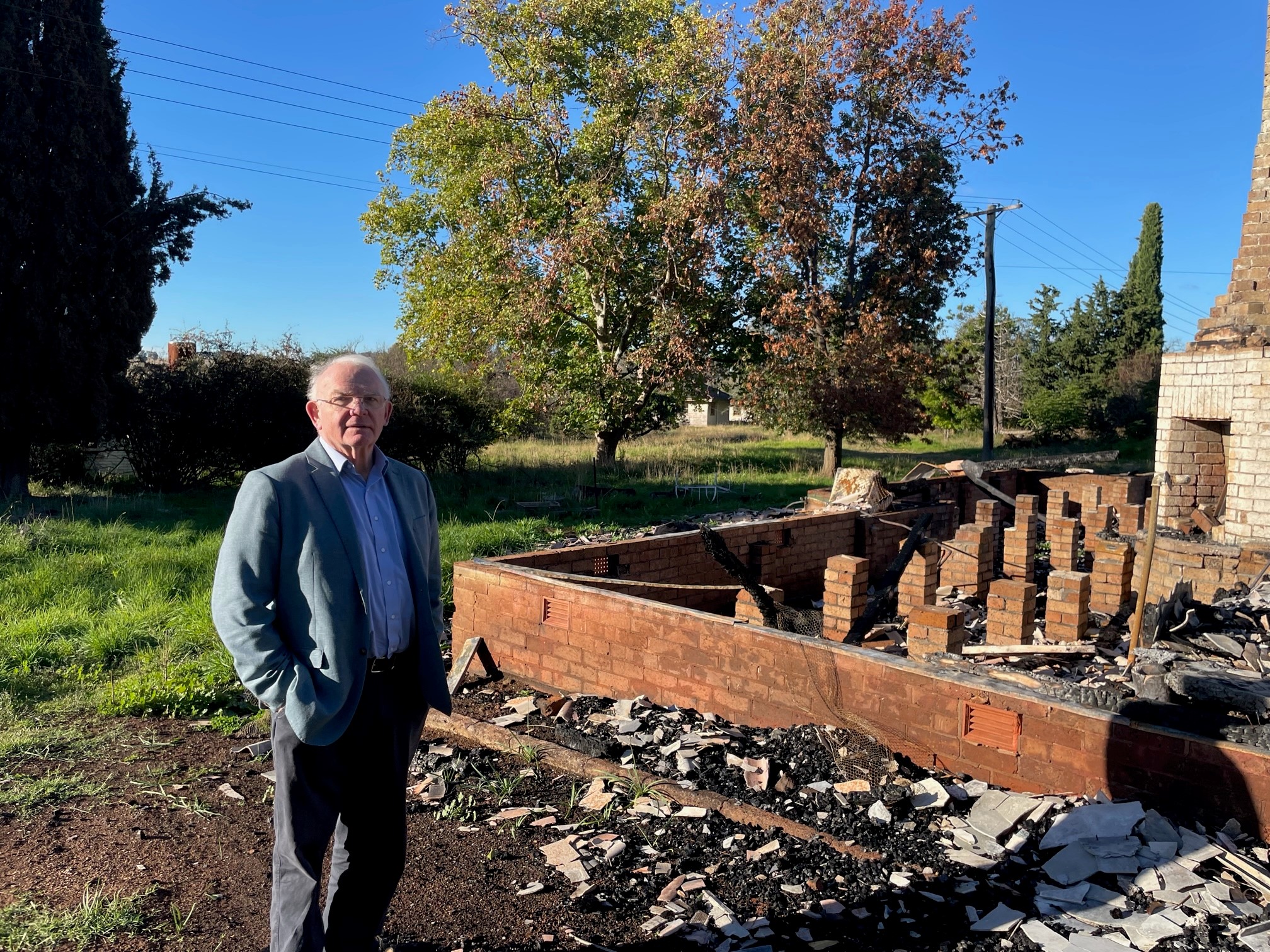 David Hill next to the burnt out remains of 'Molong Cottage' at Fairbridge Farm Molong, New South Wales, on April 20, 2022
