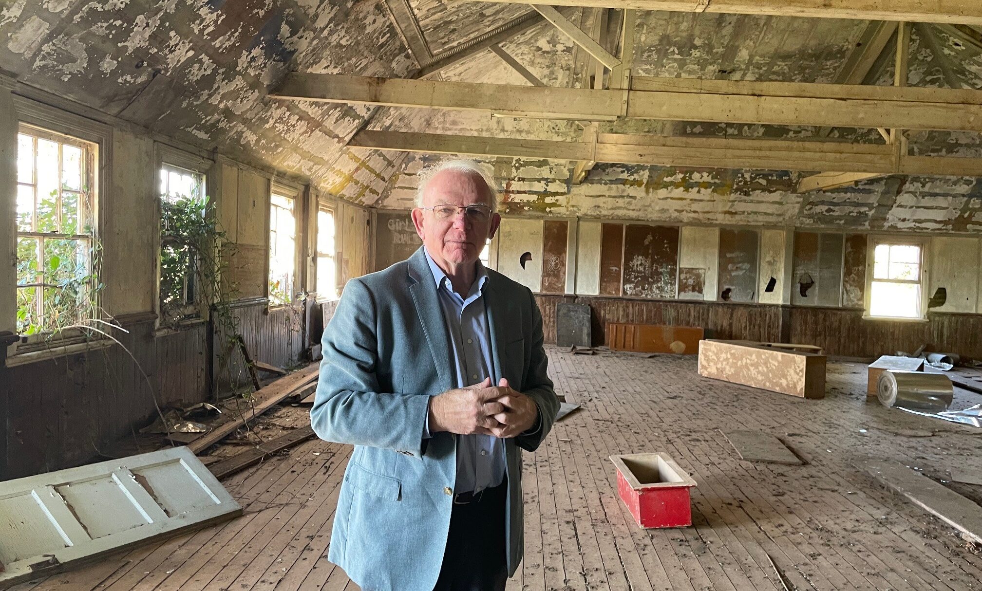 Former child migrant and author David Hill inside Nuffield Hall at Fairbridge Farm School Molong