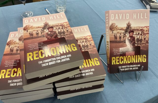 A stack of copies of the book Reckoning by David Hill