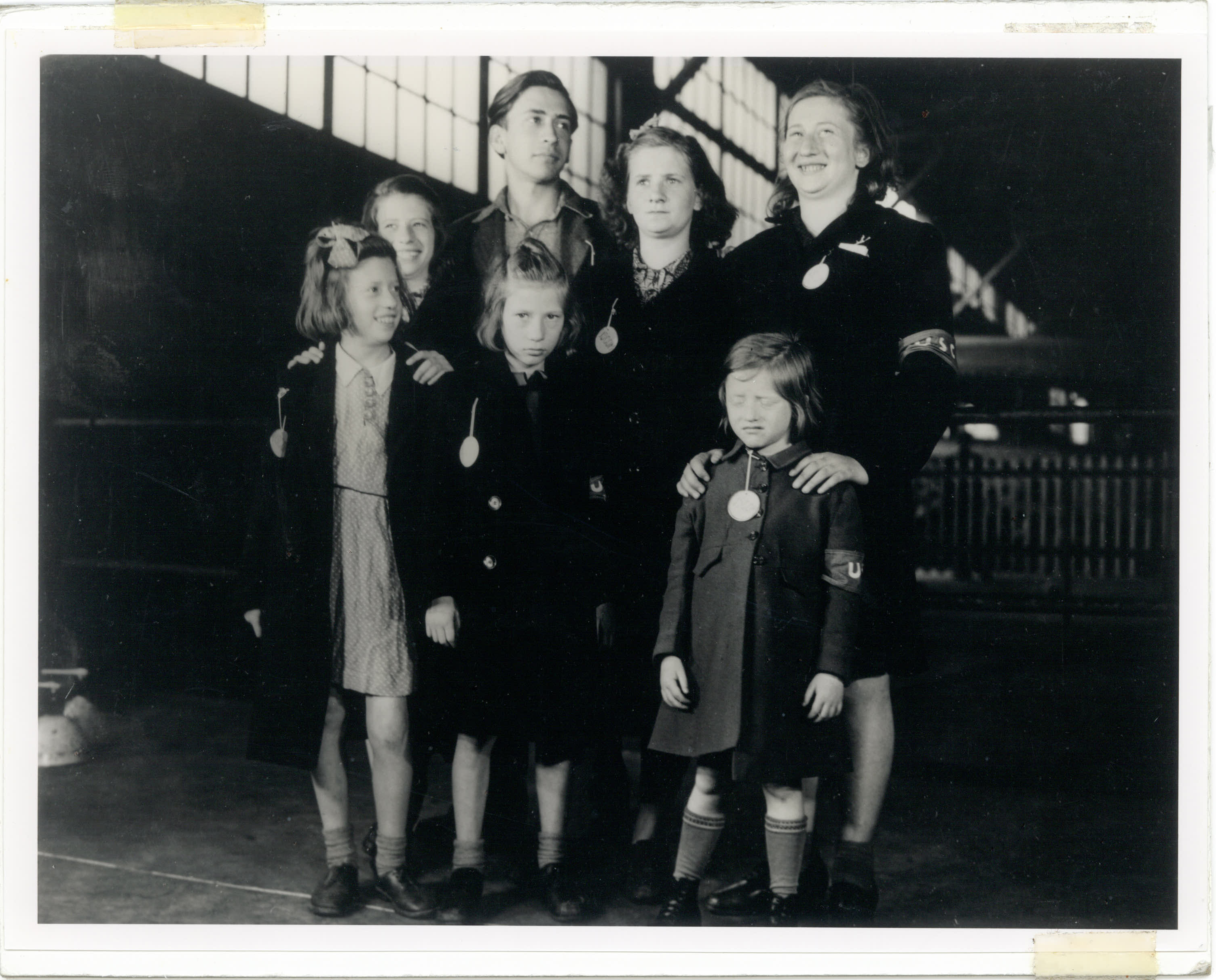In this May 26, 1946, photo, Ginger Lane, bottom right, and her siblings arrive in New York City as Holocaust survivors who were hidden in a fruit orchard near Berlin by non-Jews. Their mother was killed at the death camp at Auschwitz