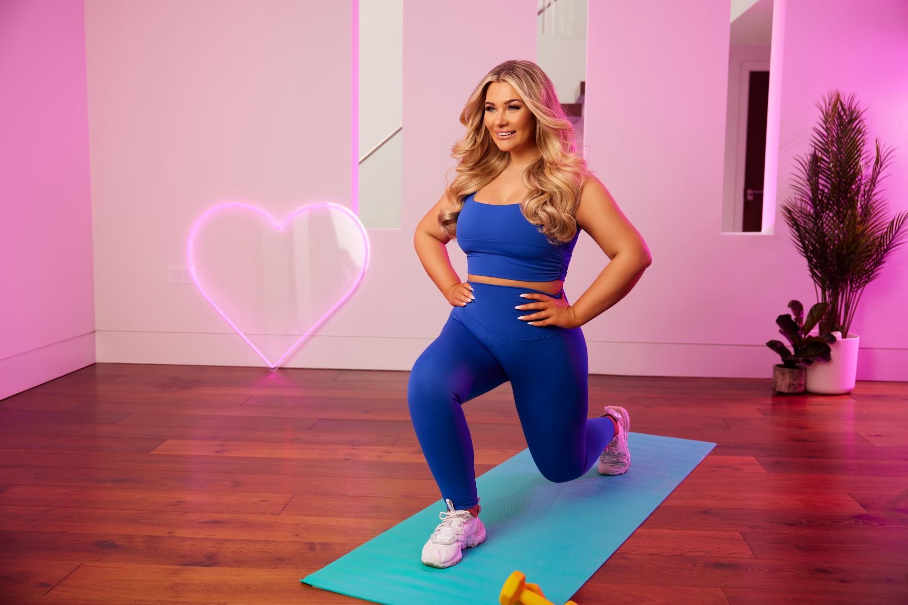 Shaughna Phillips doing exercise, wearing a blue outfit.