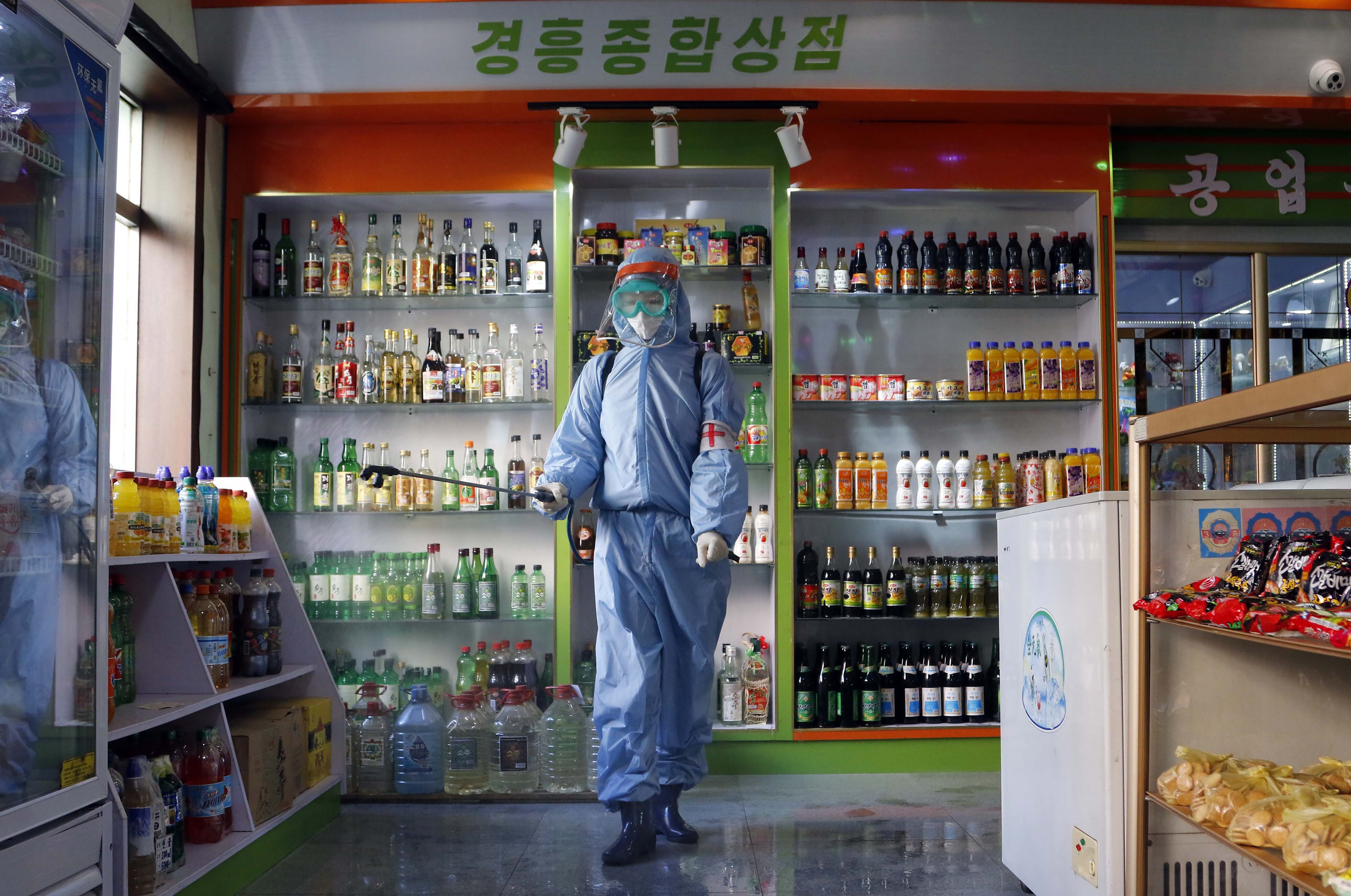 An employee of the Kyonghung Foodstuff General Store disinfects the showroom in Pyongyang, North Korea, Wednesday, Nov. 10, 2021