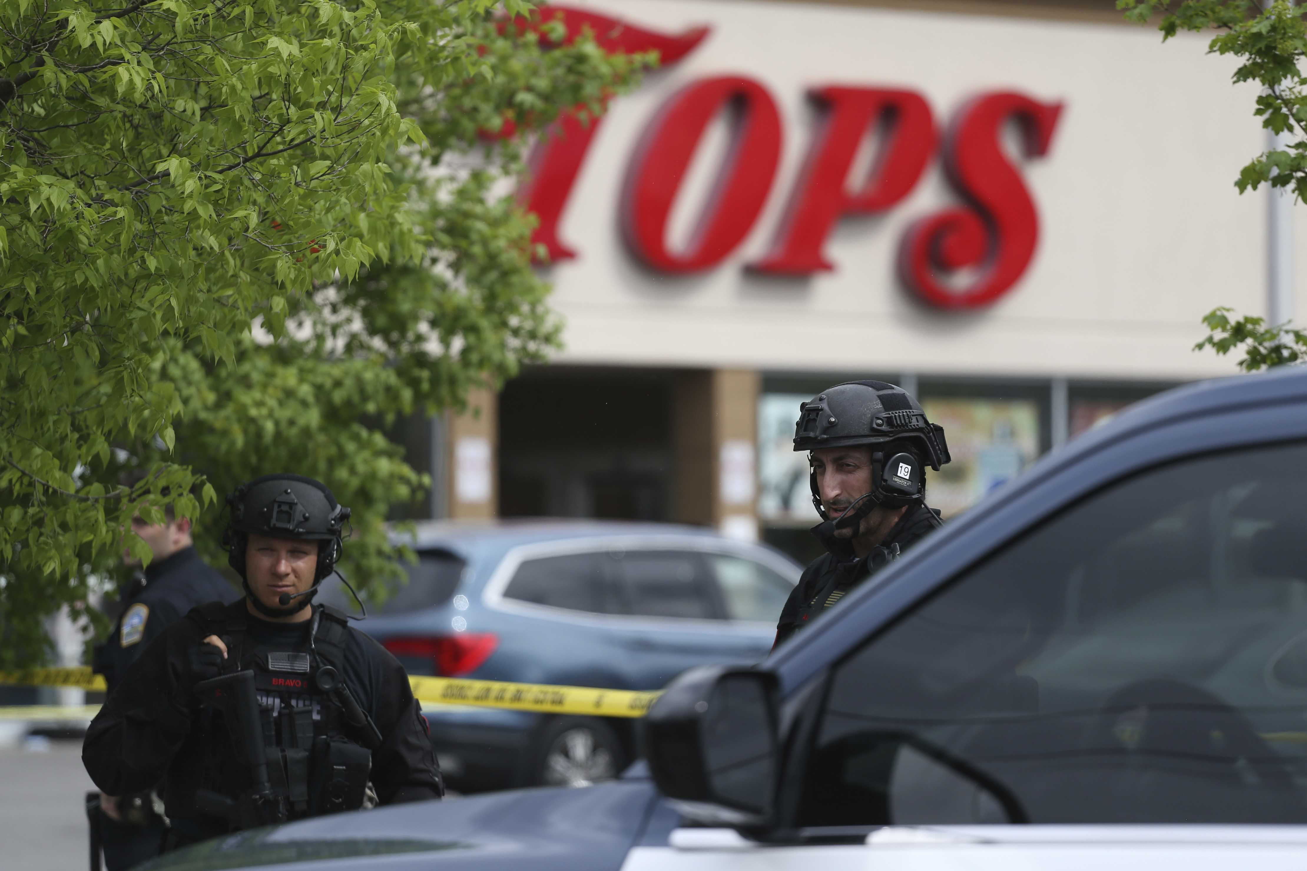 Police secure a perimeter after a shooting at a supermarket