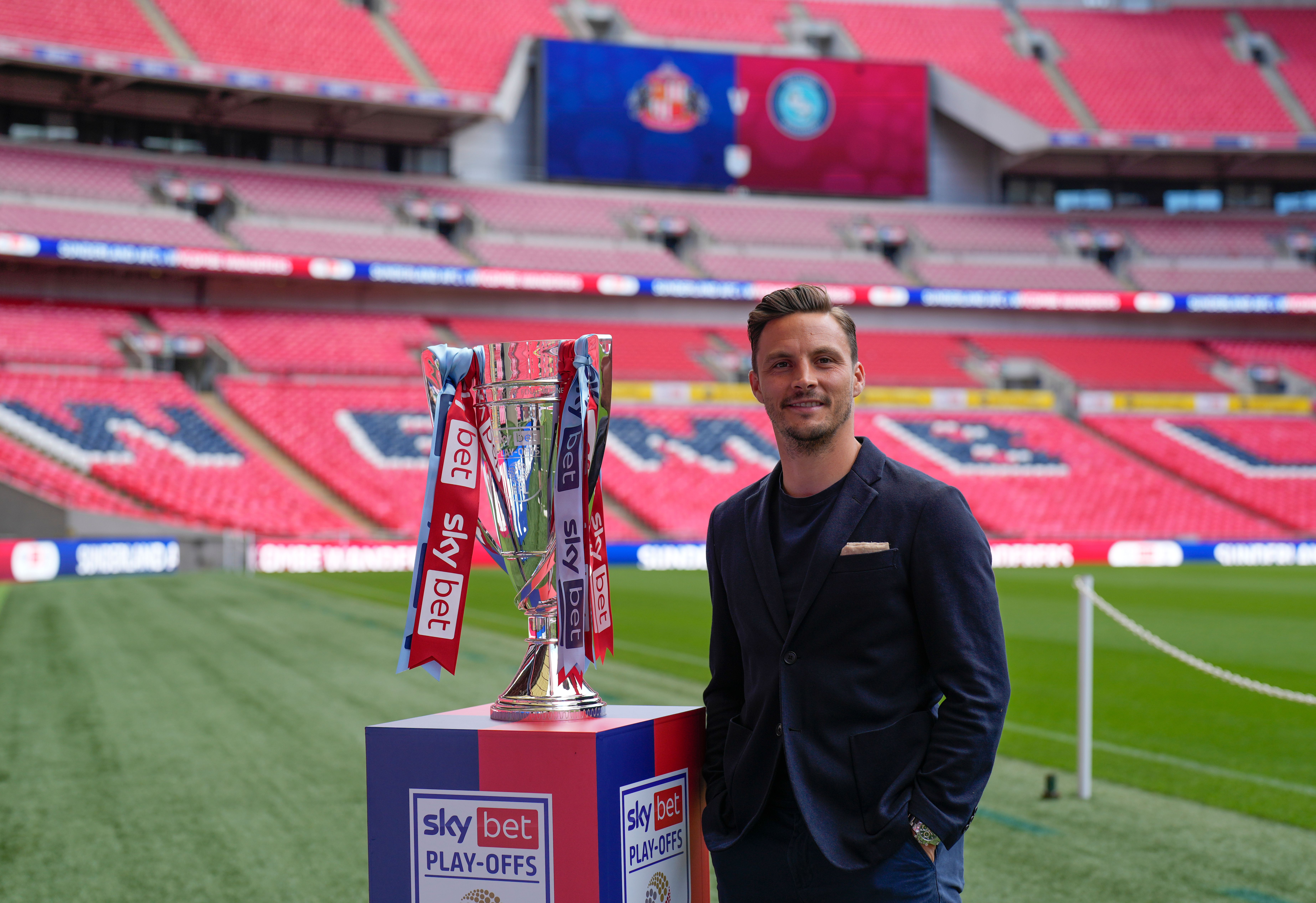Sam Saunders poses with the play-off trophy