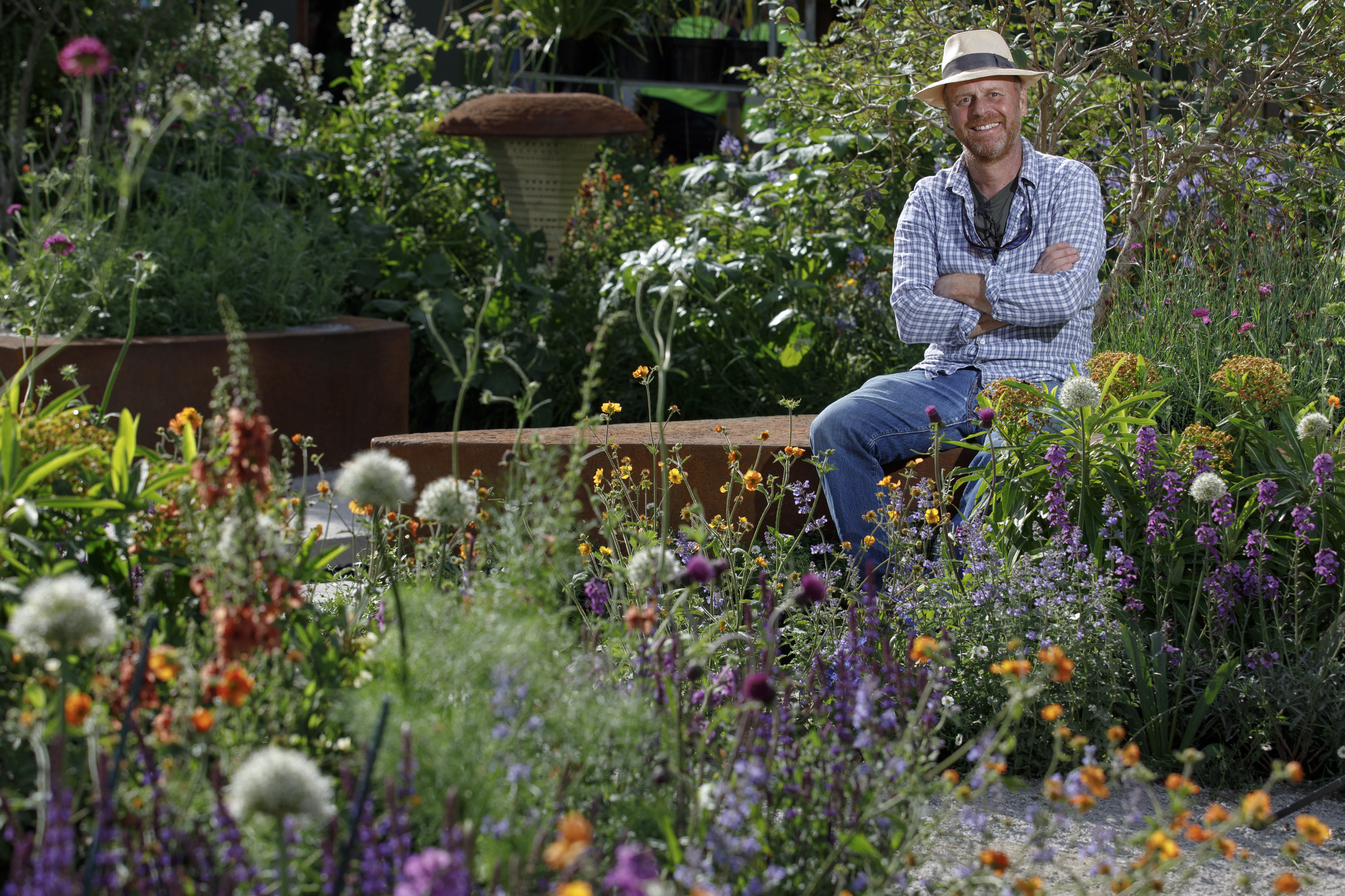 Garden designer Joe Swift in the BBC Studios Our Green Planet and RHS Bee Garden he designed, a space filled with plants for pollinators