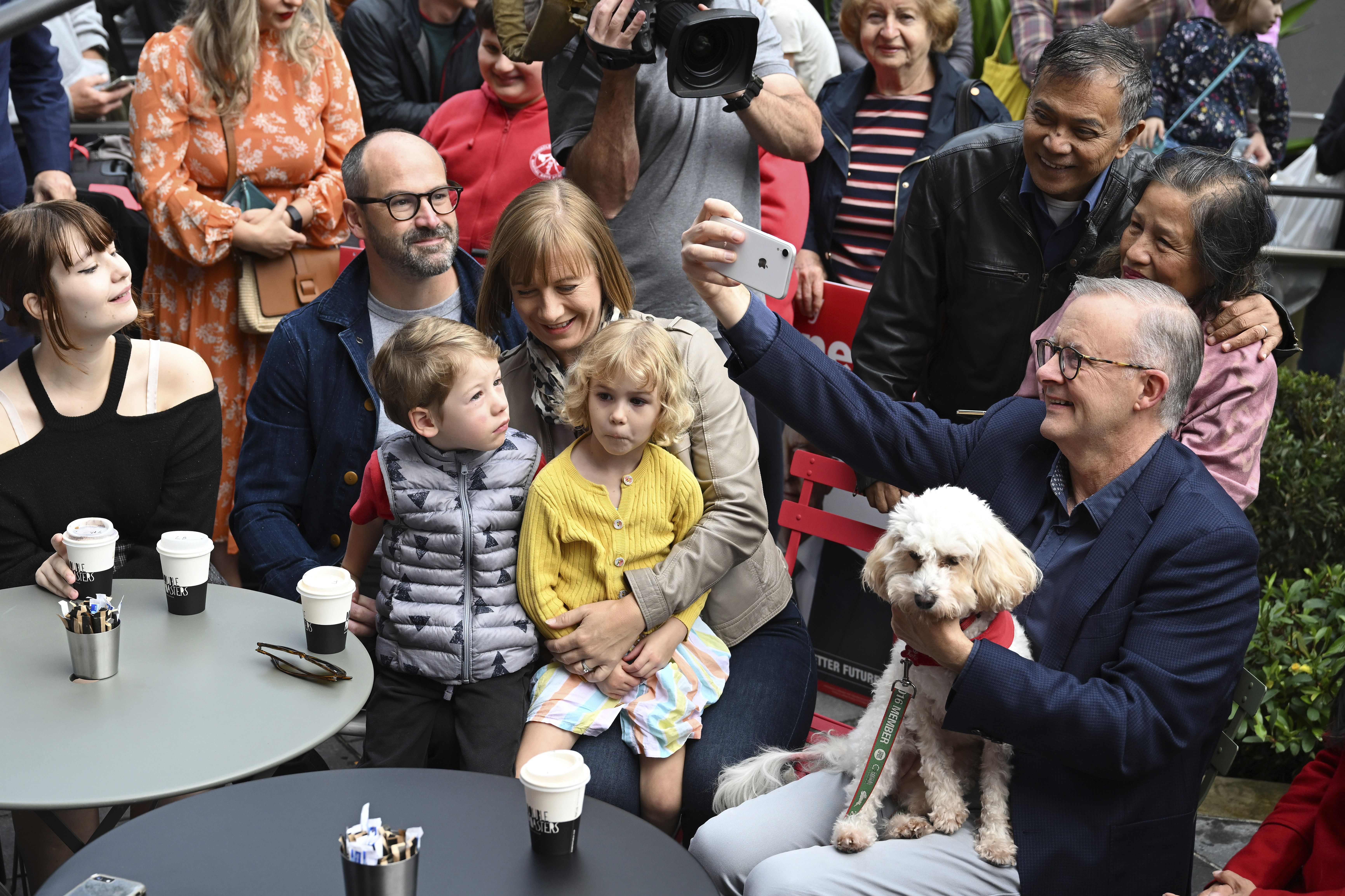 Mr Albanese with his dog Toto with community members in Sydney