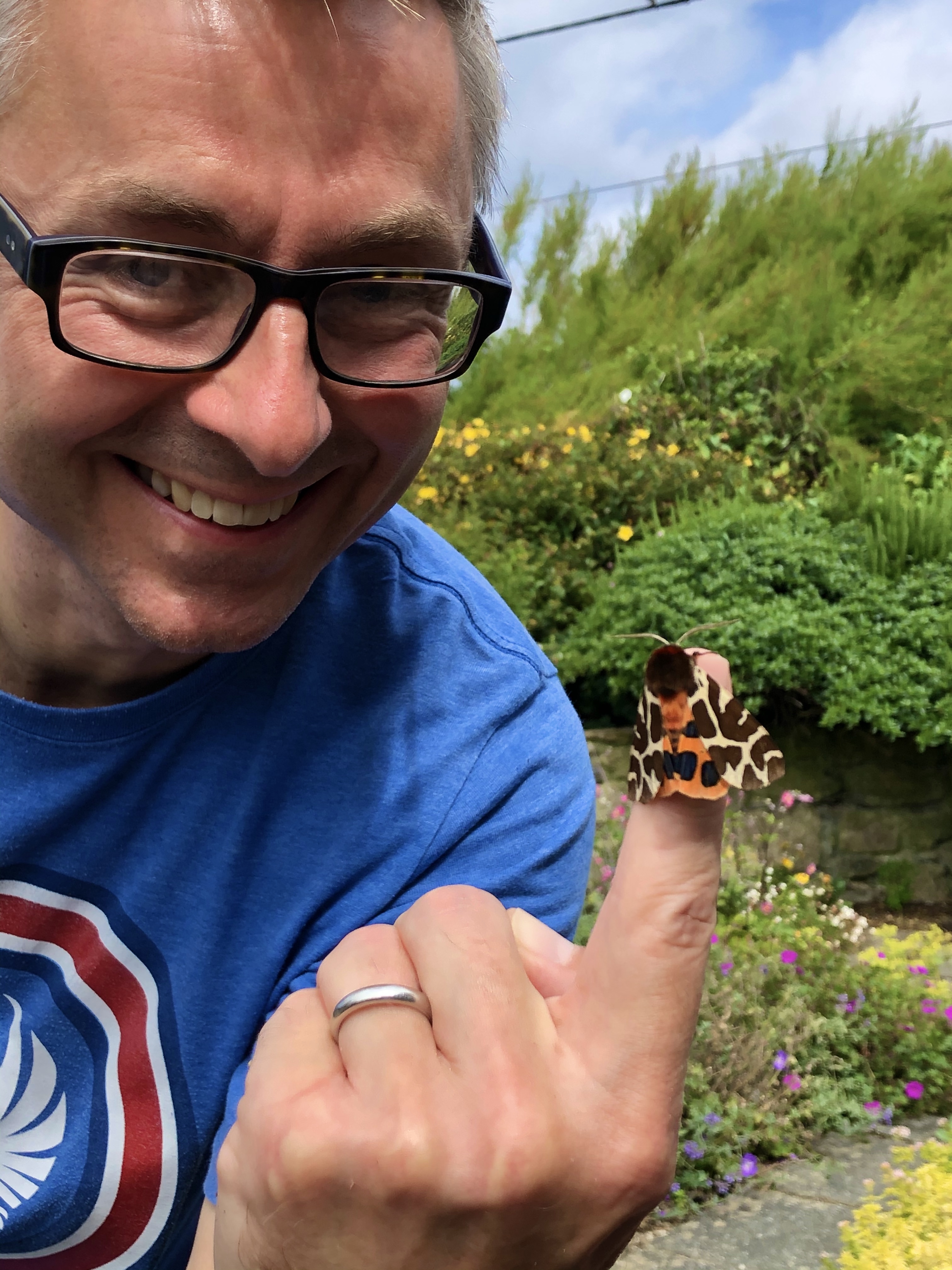 Dr Richard Fox with a butterfly on his fingertip (Butterfly Conservation/PA)