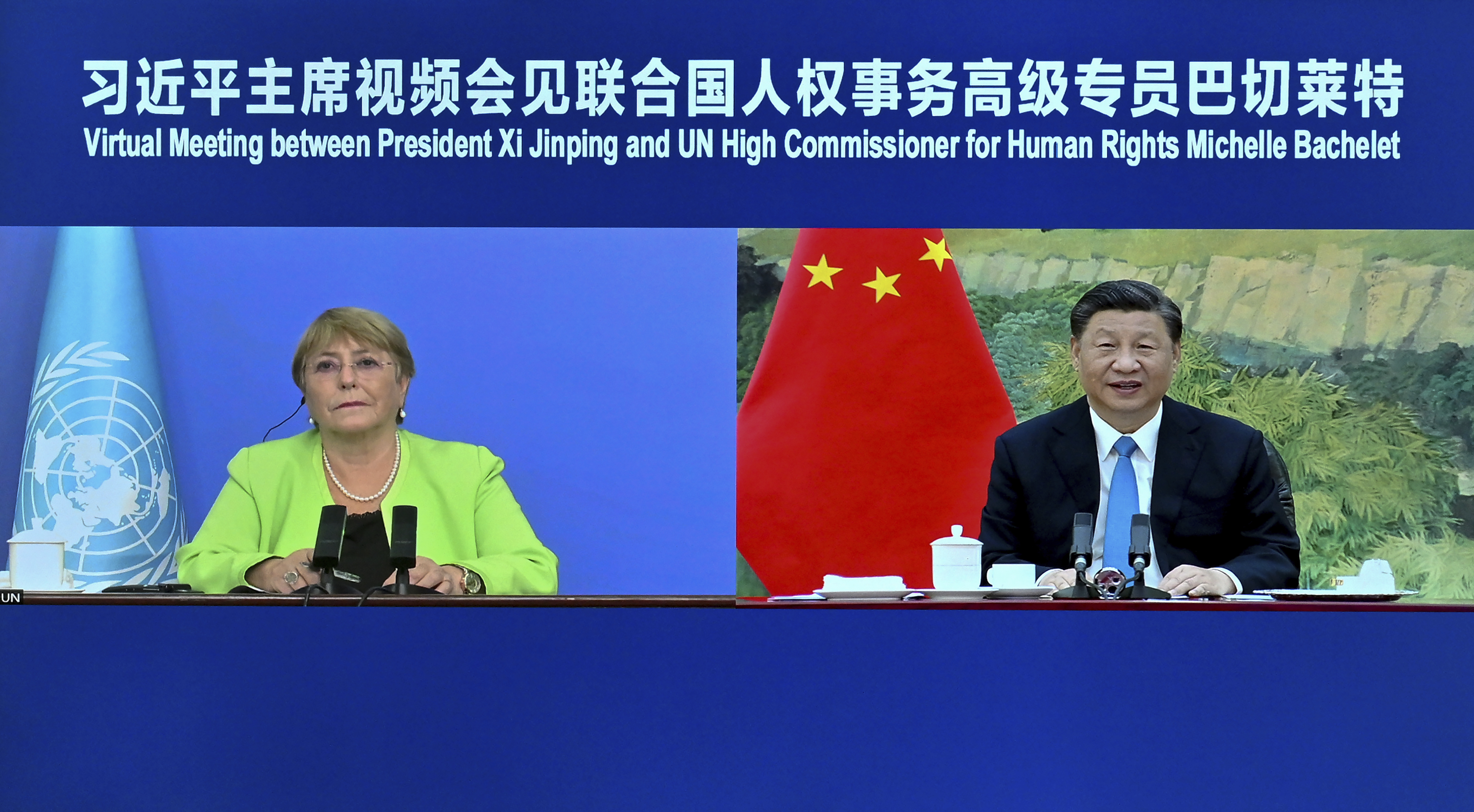 A screen showing Xi Jinping holding a virtual meeting with Michelle Bachelet