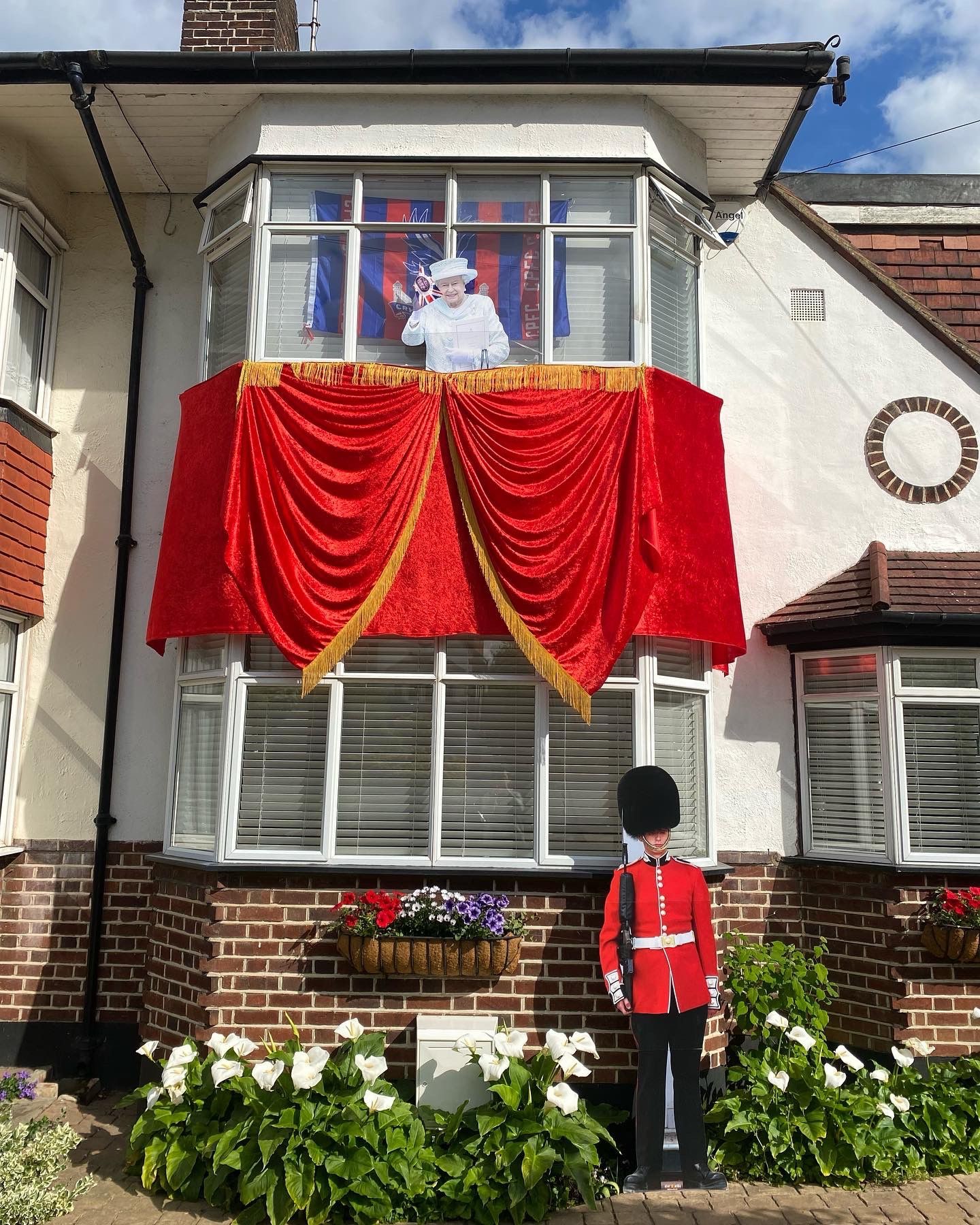 Decorations including a life-size cut-out of the Queen at a home in Bromley, south London (Athina Georgiou)