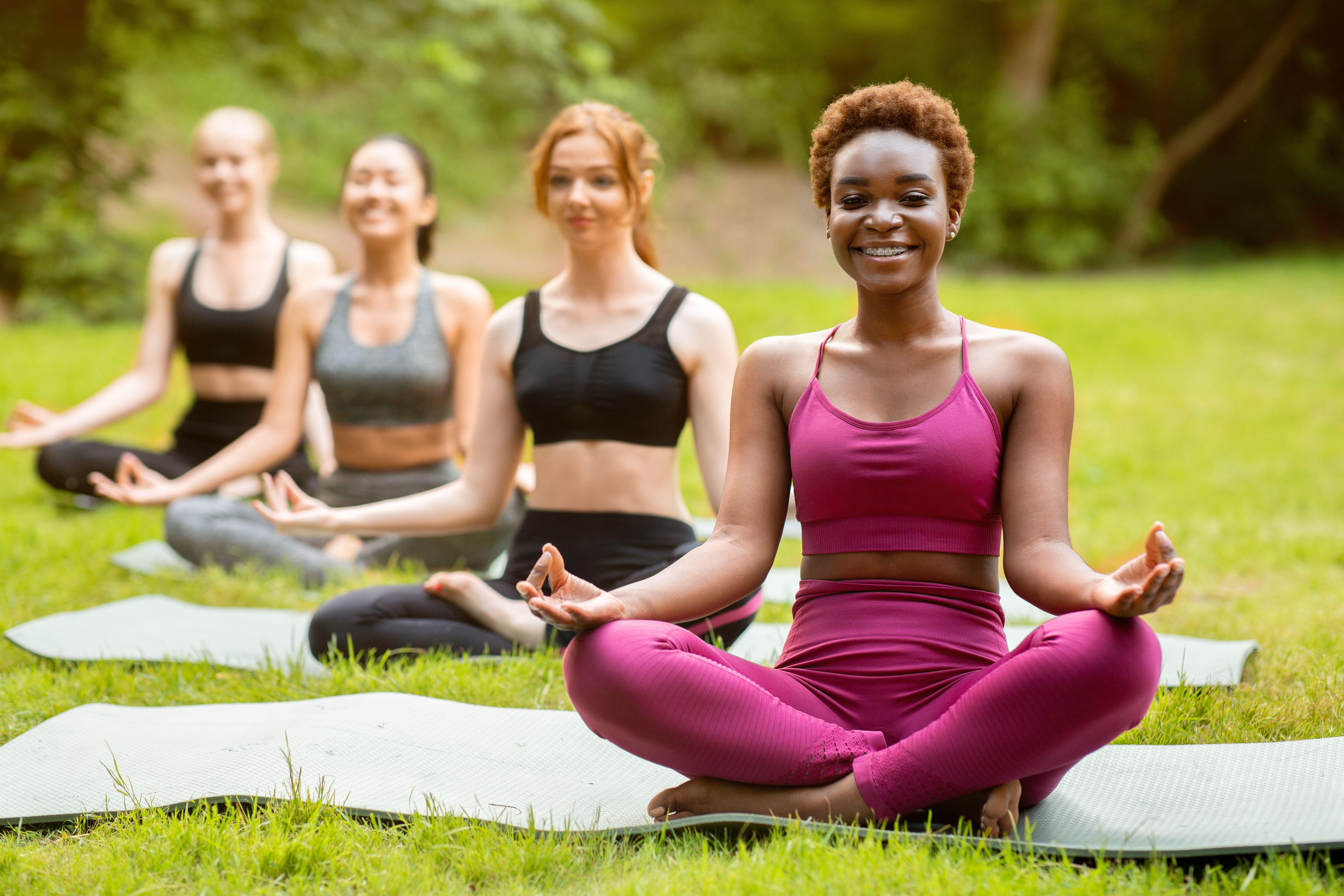 Women doing yoga in the park