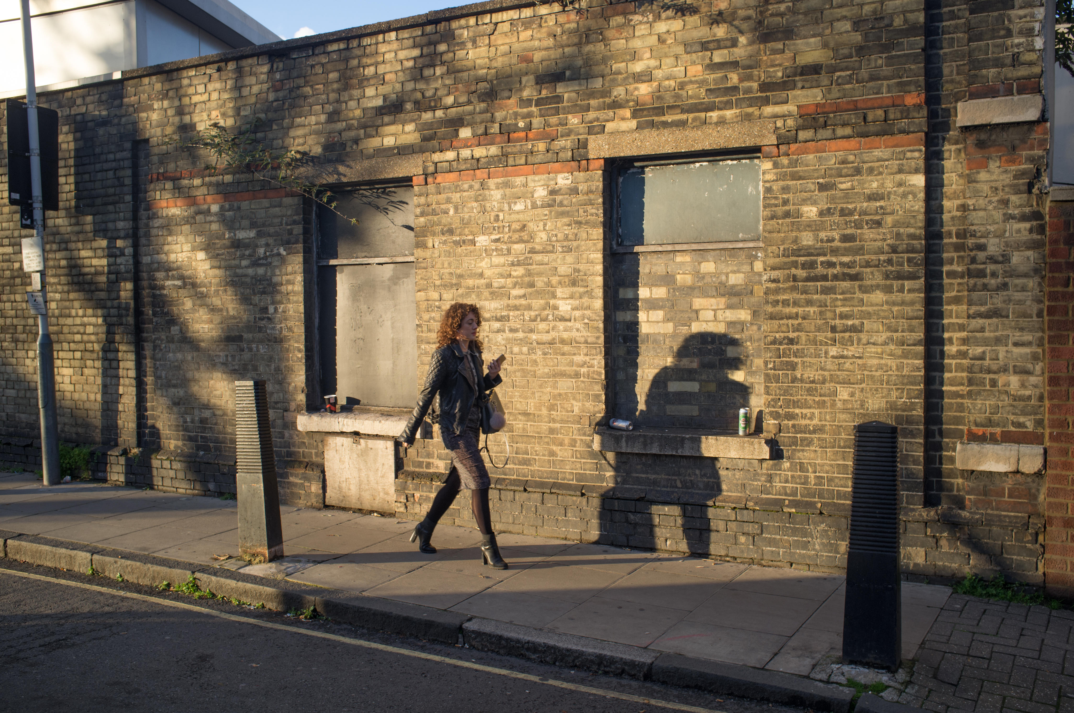A woman walking home on an autumn evening in Islington, North London