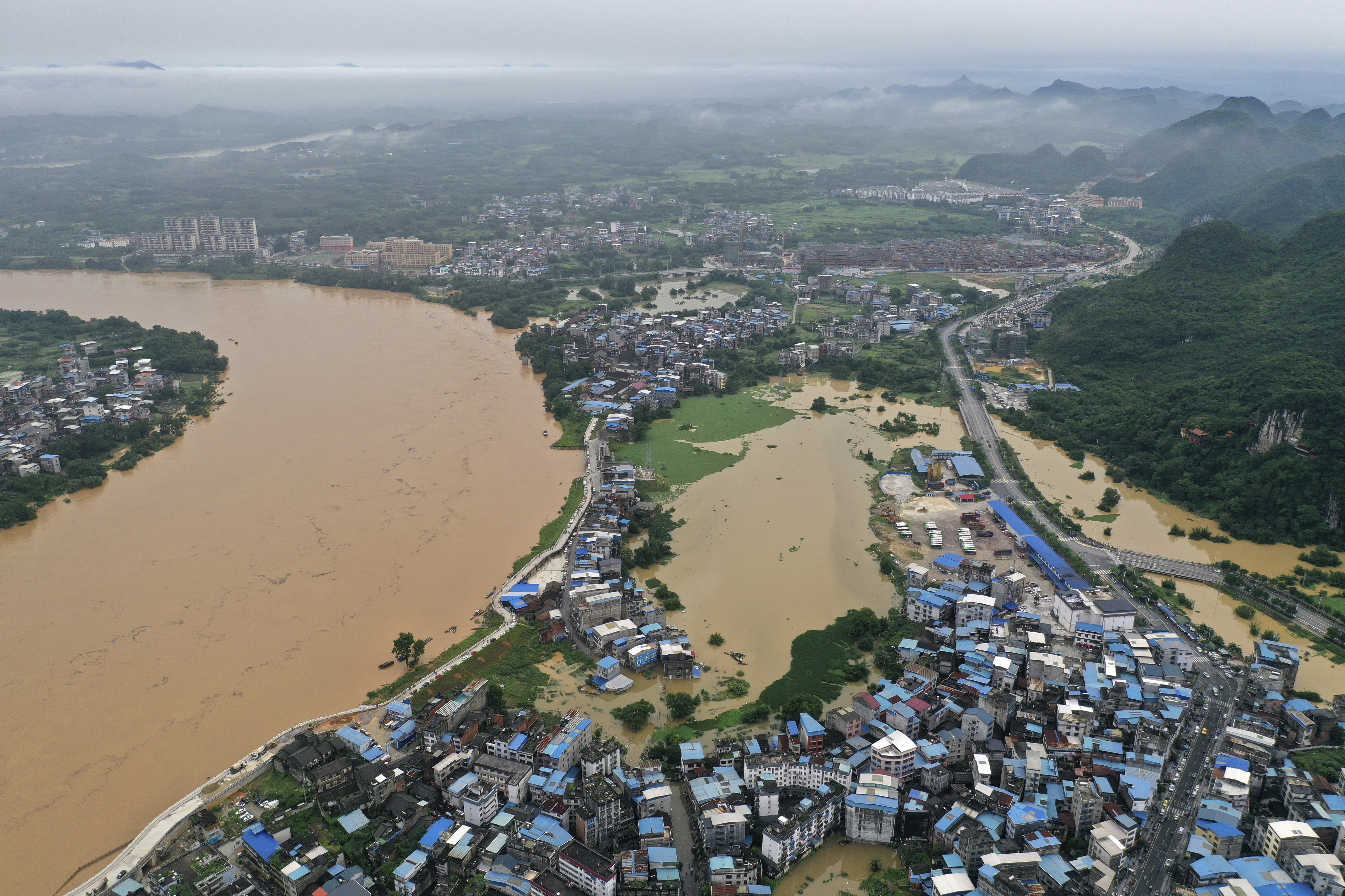 An aerial view shows a flooded areas along the Rongjiang River after heavy rainfalls in the Rongshui Miao Autonomous County, southern China's Guangxi Zhuang Autonomous Region (Huang Xiaobang/Xinhua/AP)