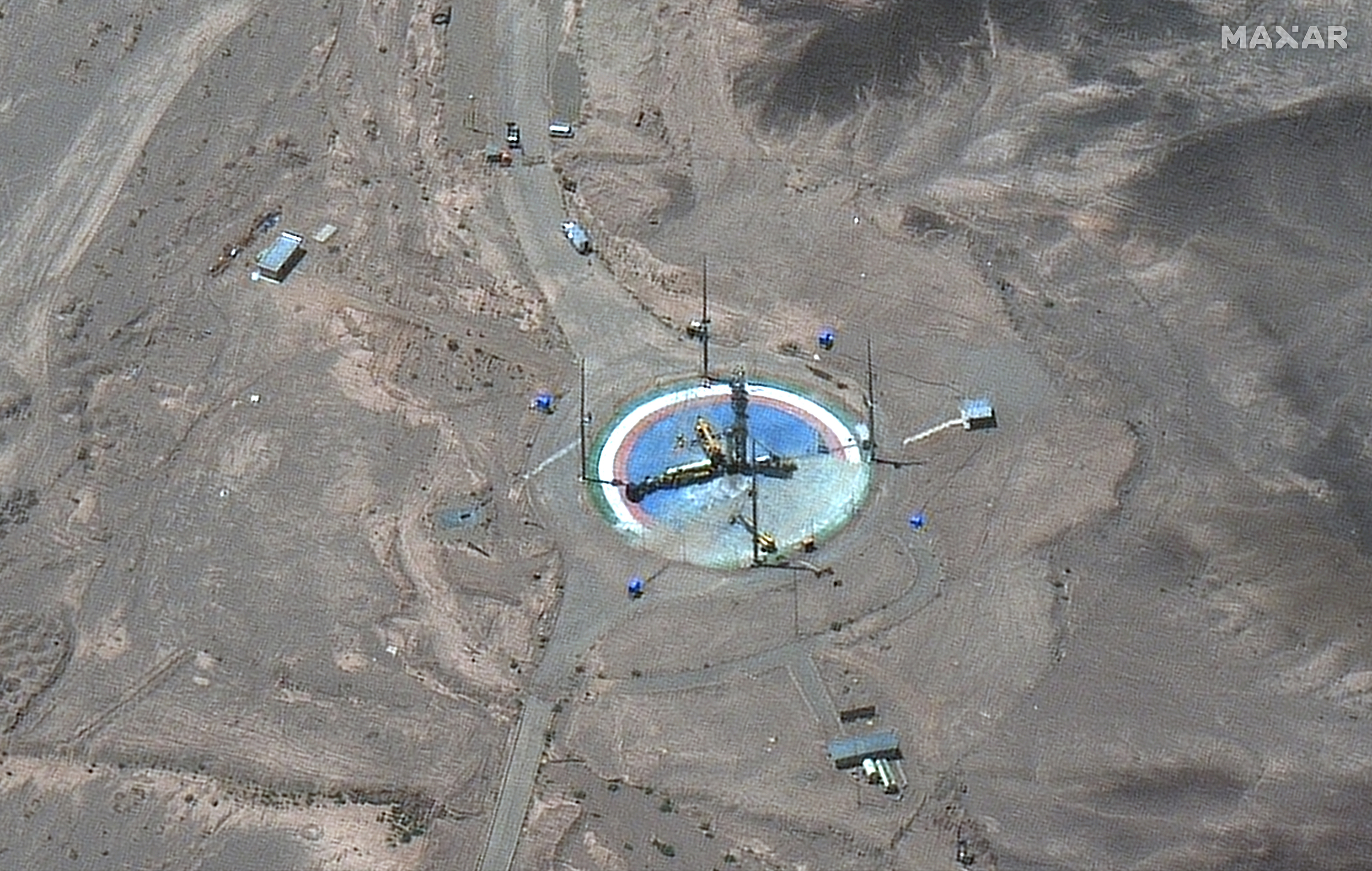 A satellite image shows a rocket preparing to be erected at a launch pad 