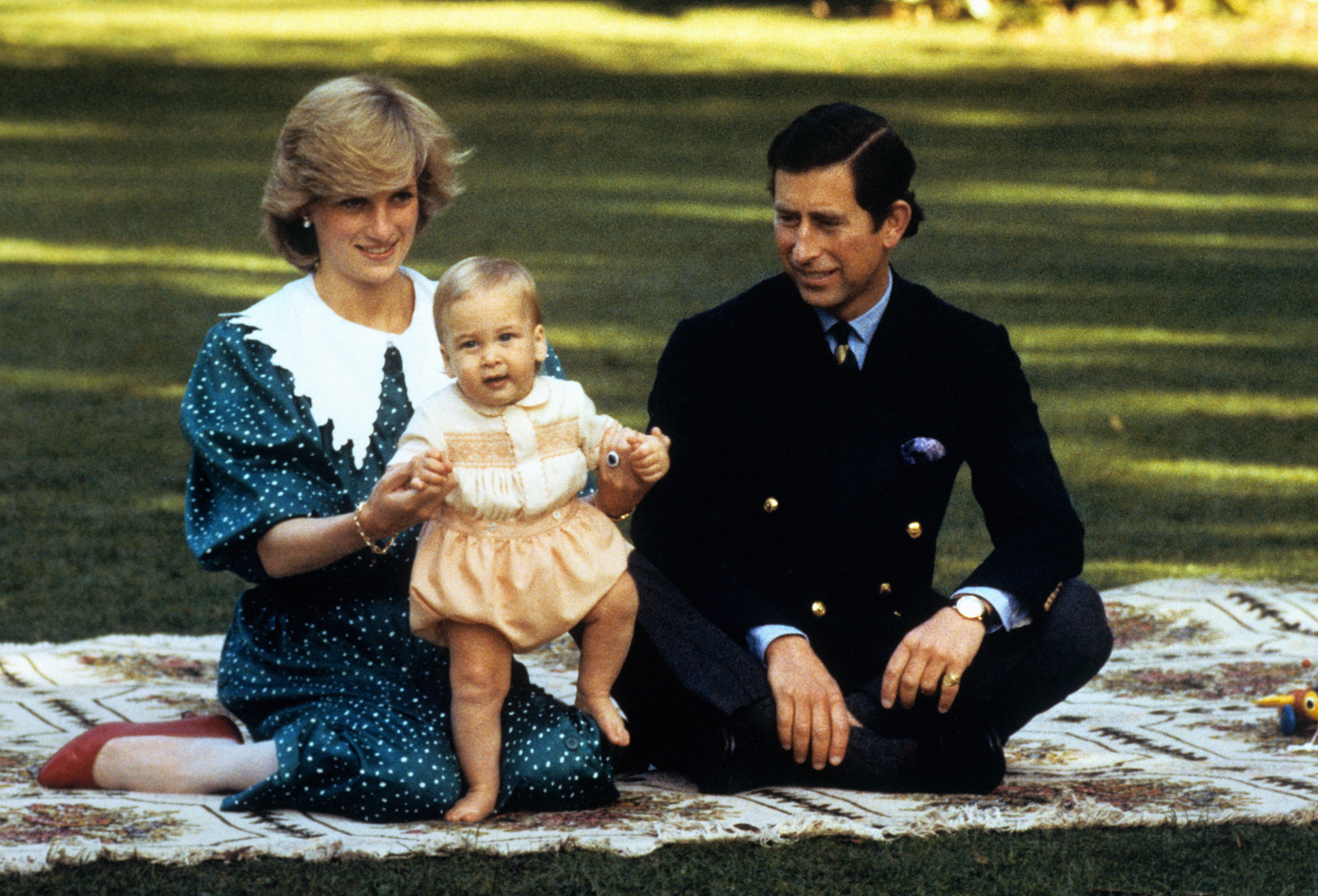 The Prince and Princess of Wales amuse baby Prince William in the grounds of Government House in Auckland, New Zealand in 1983
