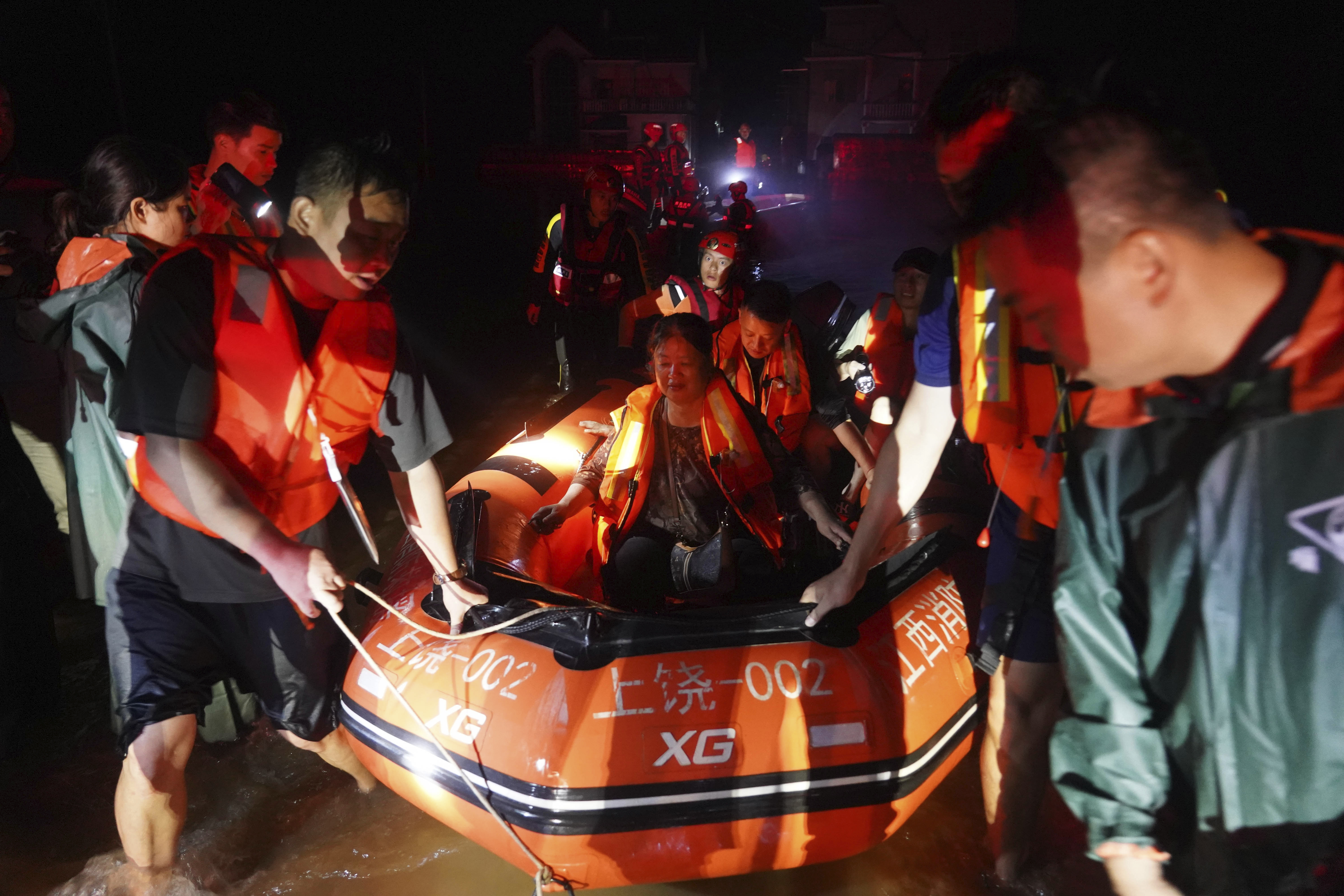 Rescuers evacuate stranded people in floodwater in Dexing, south-eastern China's Jiangxi province