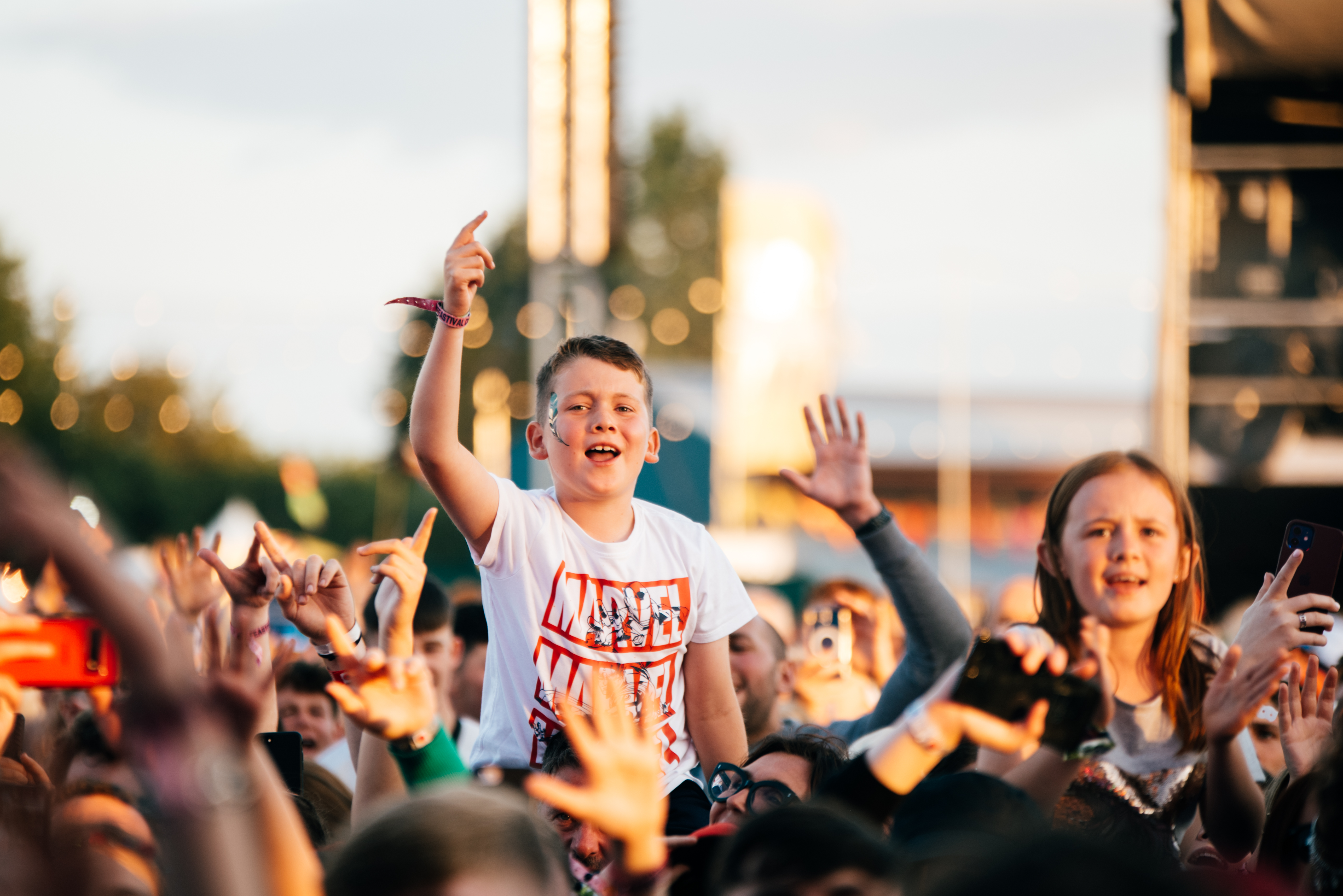 Child in a festival crowd watching music