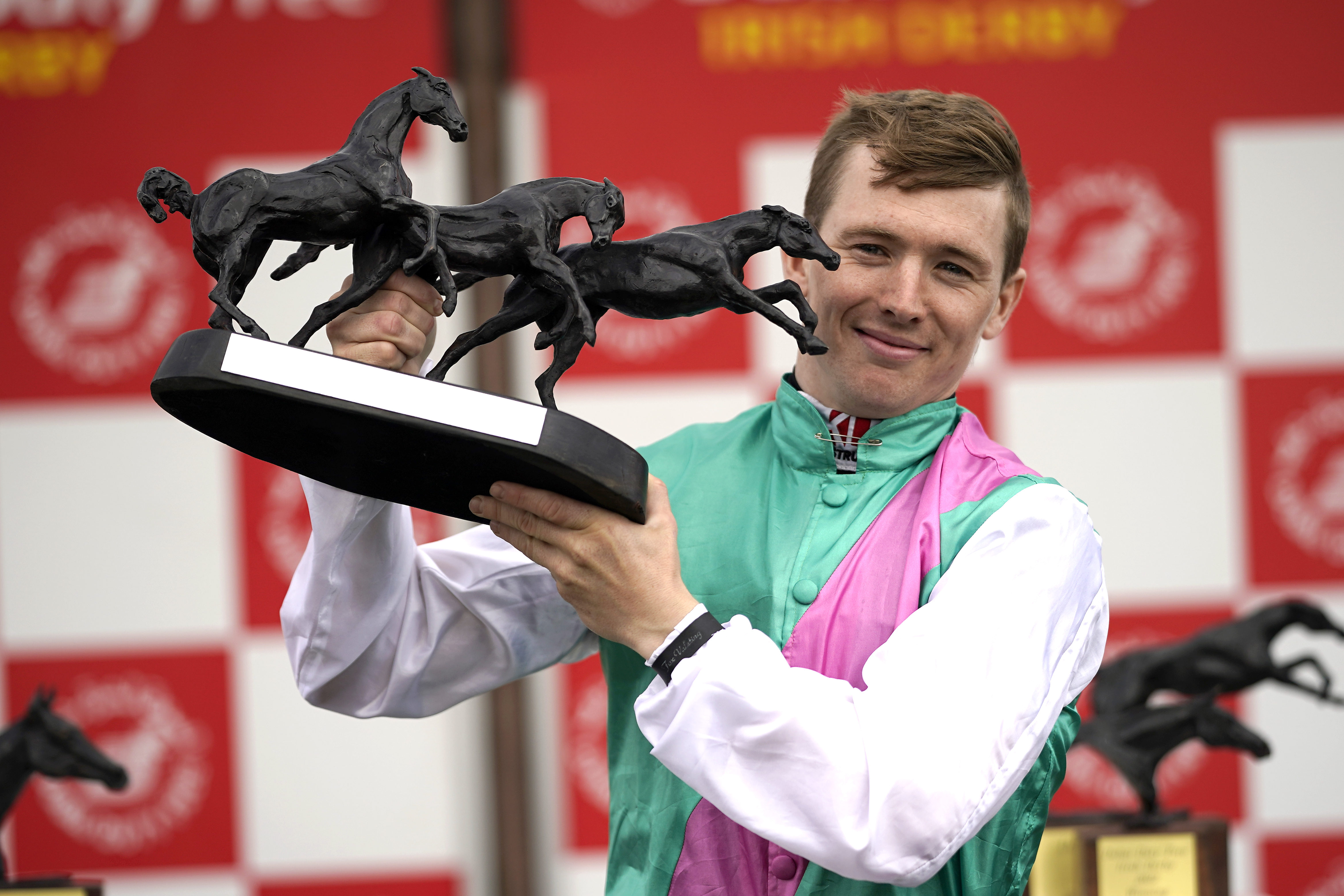 Jockey Colin Keane celebrates with the trophy after winning the Dubai Duty Free Irish Derby with horse Westover during day two of the Dubai Duty Free Irish Derby Festival at Curragh Racecourse in County Kildare, Ireland (Niall Carson/PA Wire)