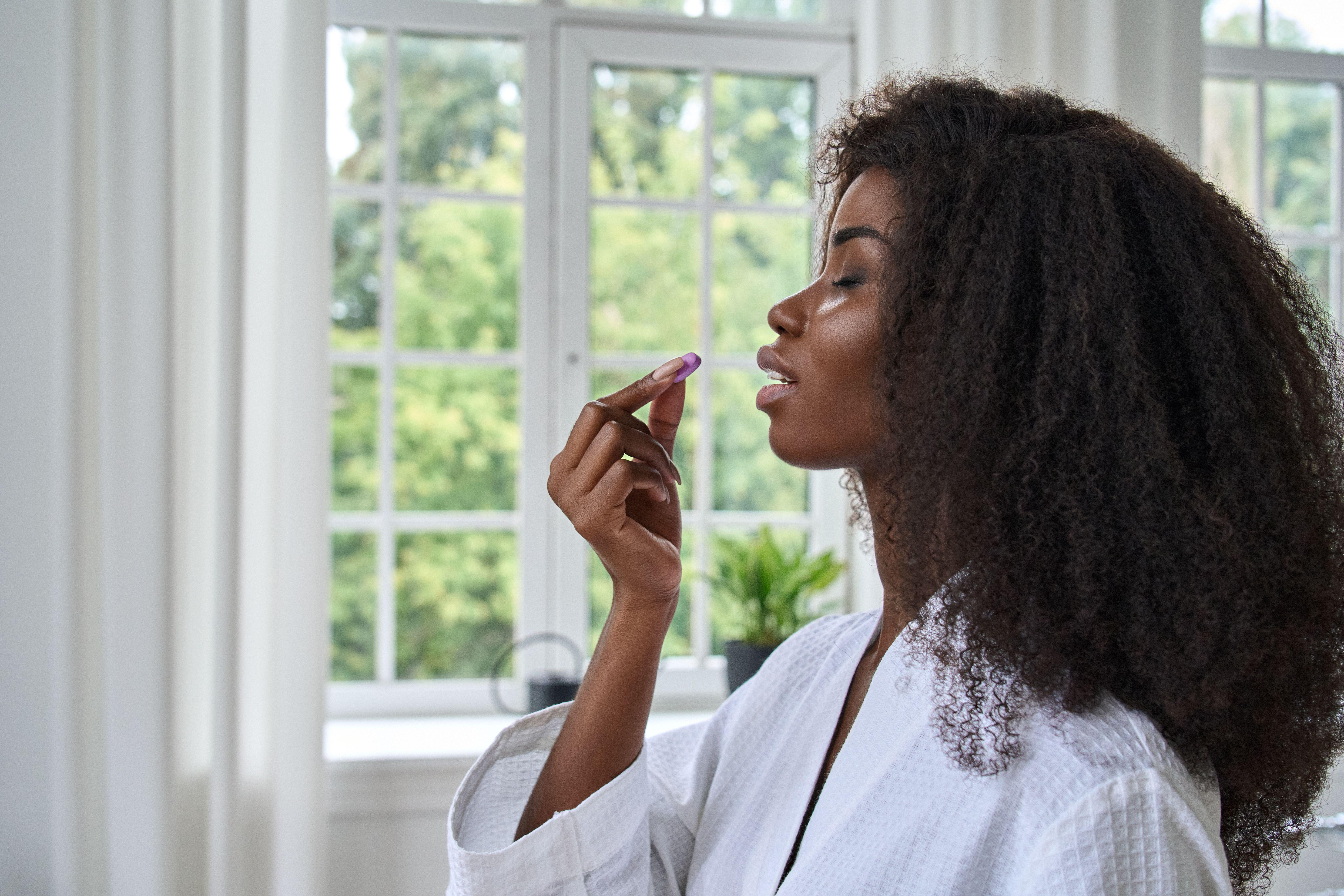 woman taking a vitamin supplement