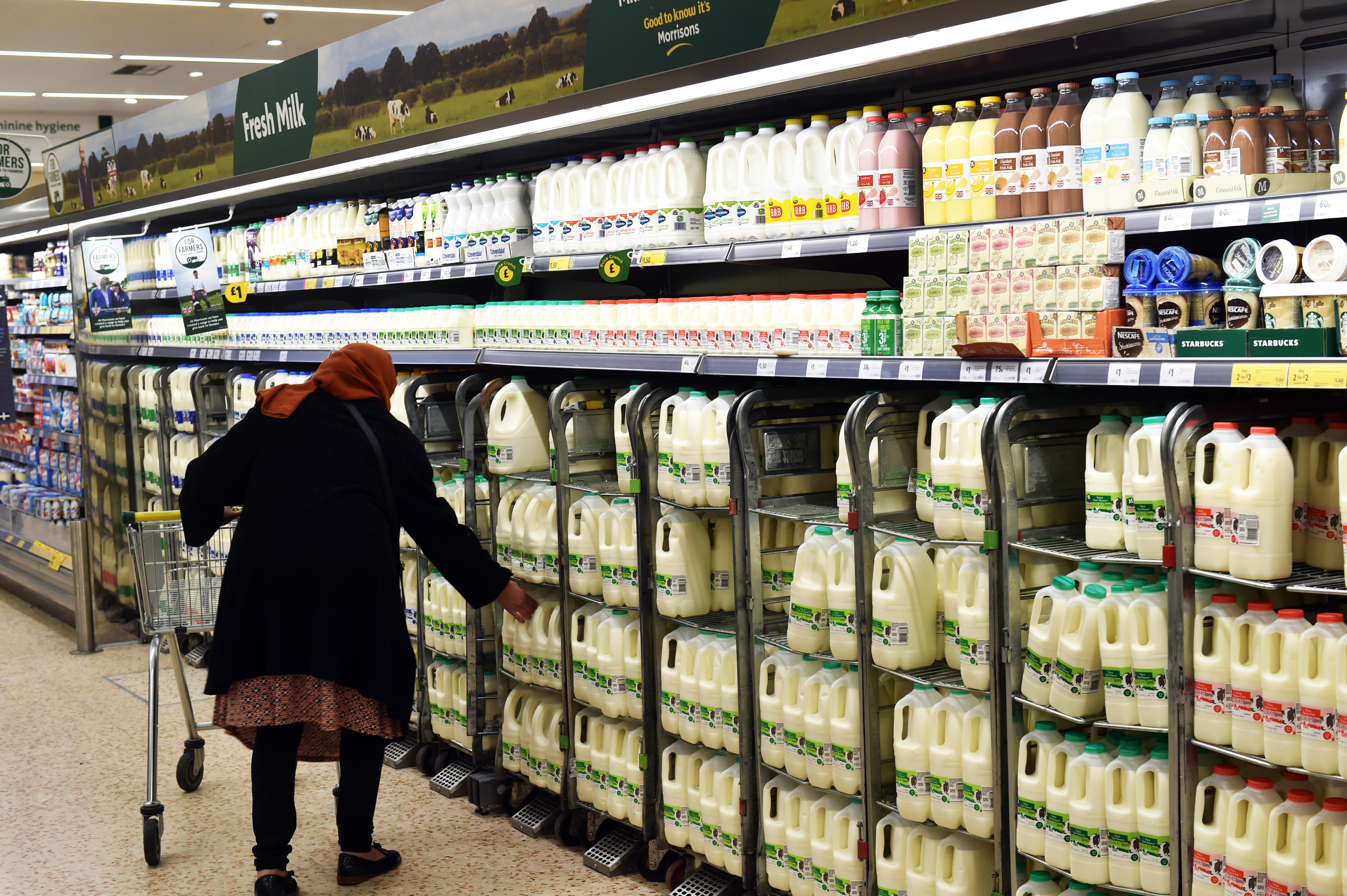 Woman buys milk from the supermarket UK