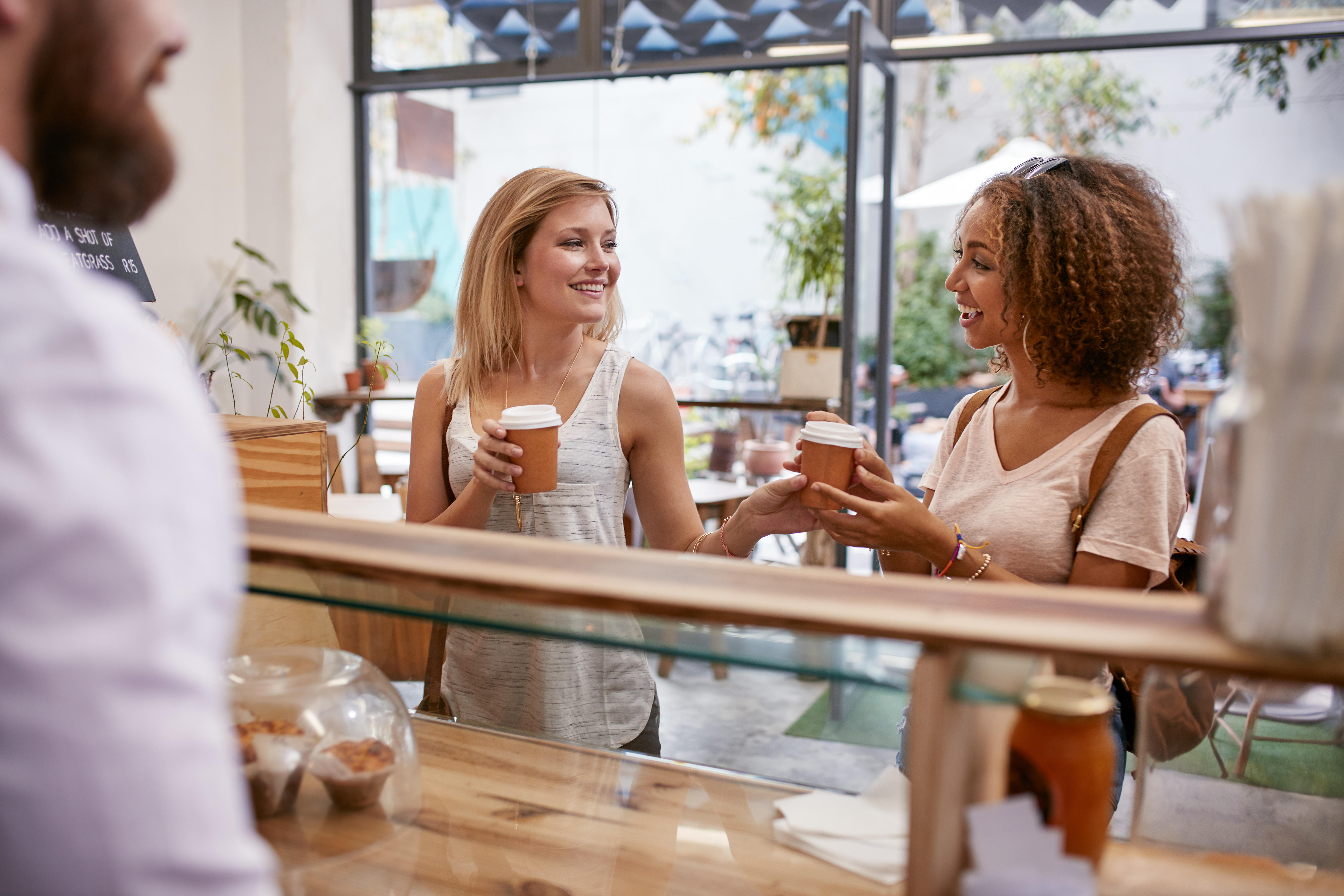 Two female friends chatting in a coffee shop