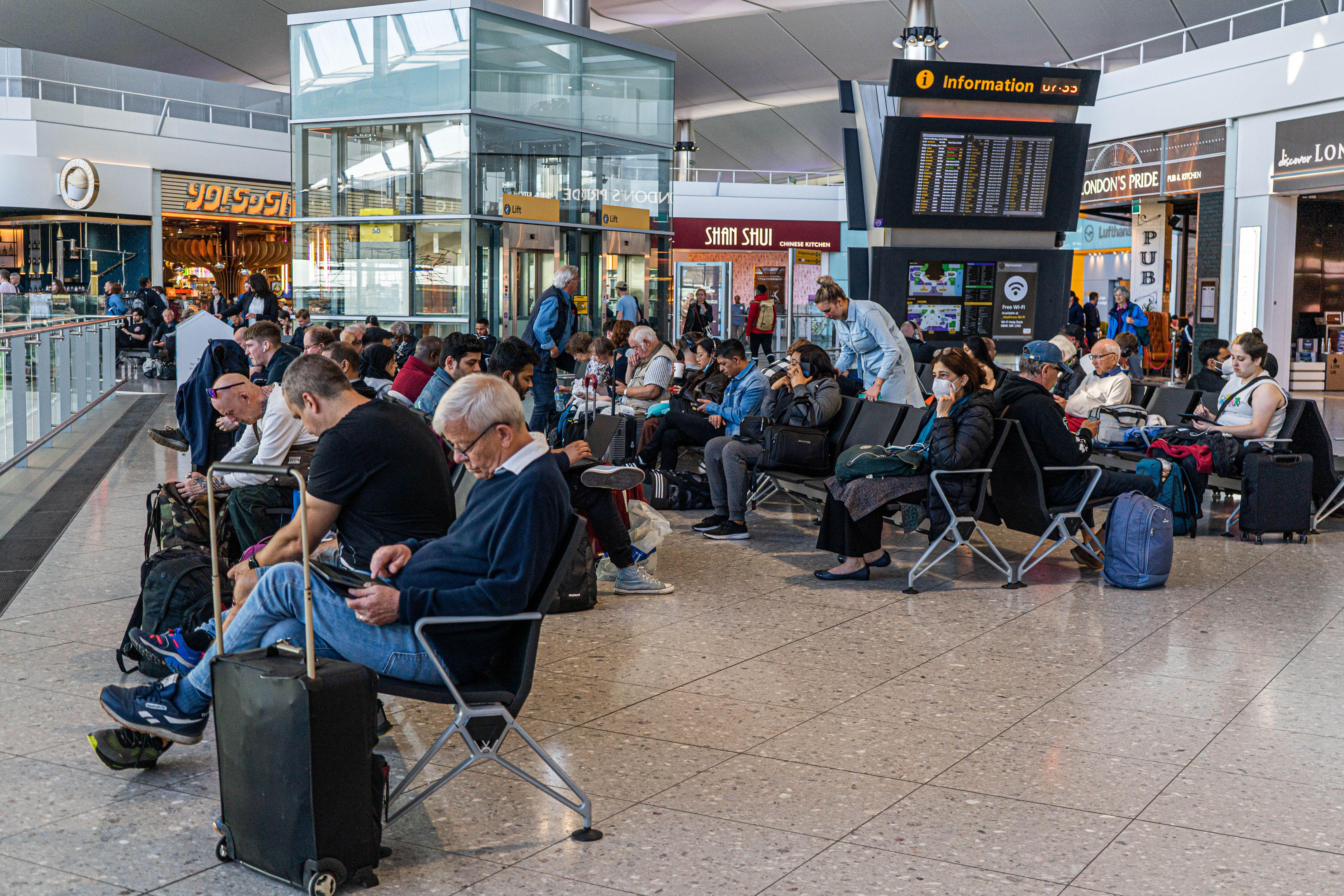 Heathrow airport Terminal 2 is busy with passengers which has been affected from severe staff shortages, leading to many flight cancellations and airport disruption and leaving potentially thousands of passengers stranded abroad
