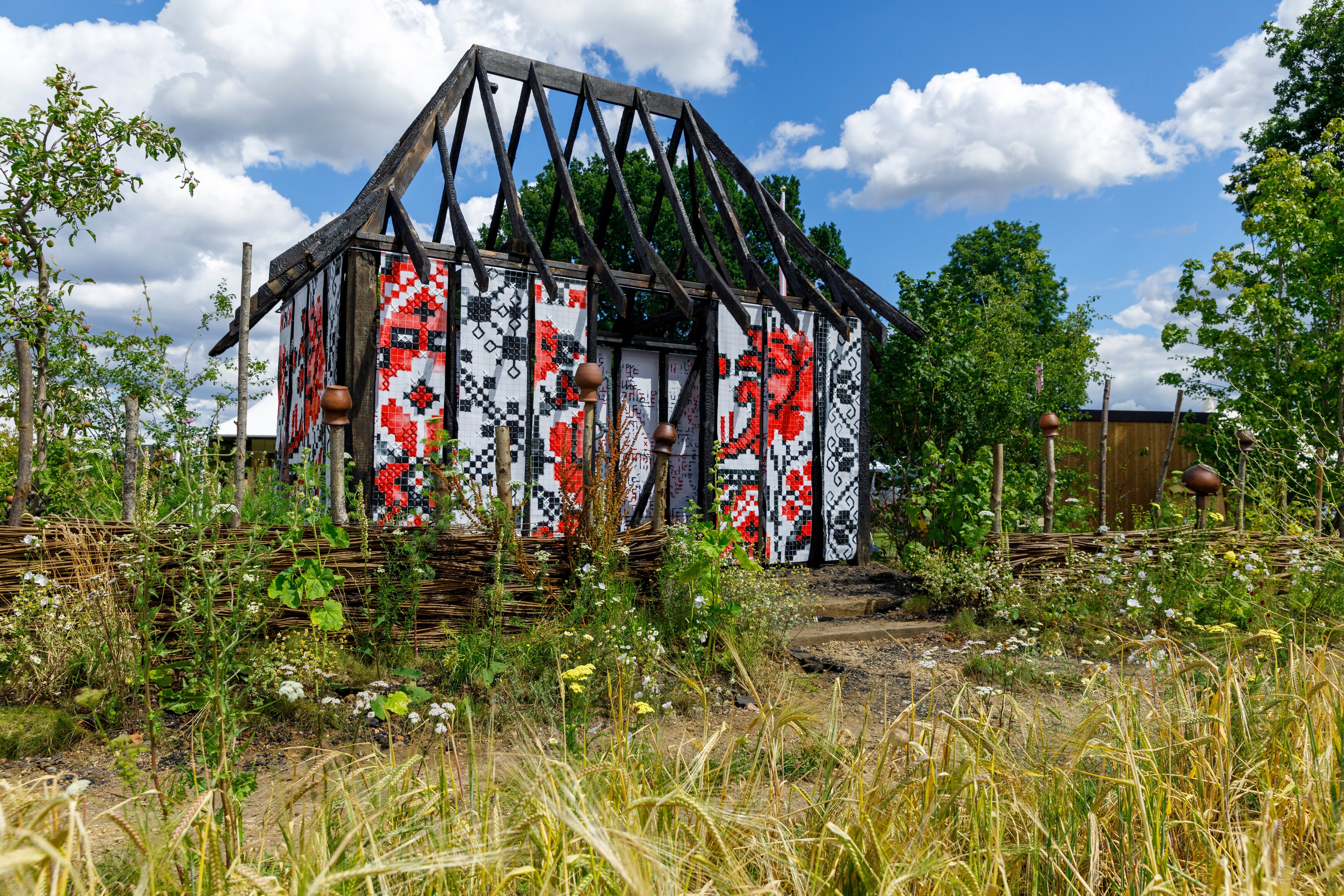 A burnt out structure in the What Does Not Burn garden 