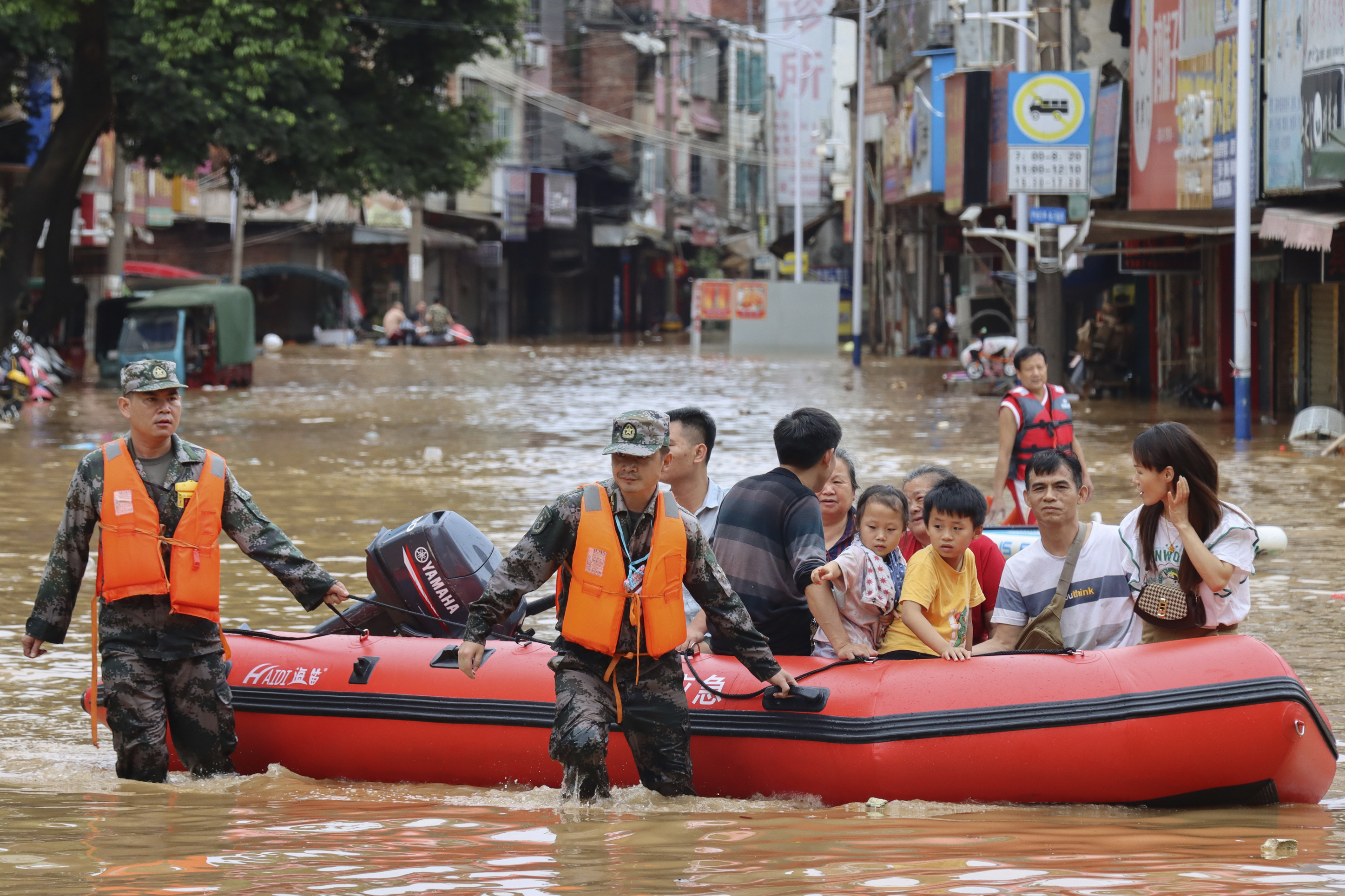 Rescuers evacuate stranded residents in flood water in Tuojiang Township, Jianghua Yao Autonomous County, Yongzhou in central China's Hunan Province