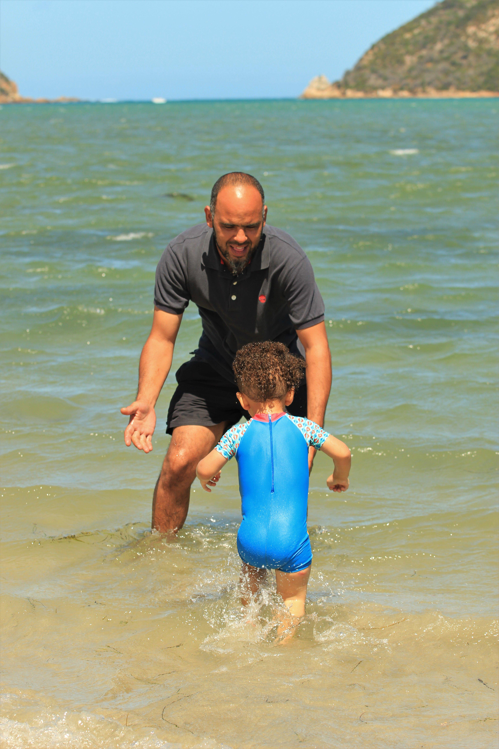 Mam playing in the sea with his son