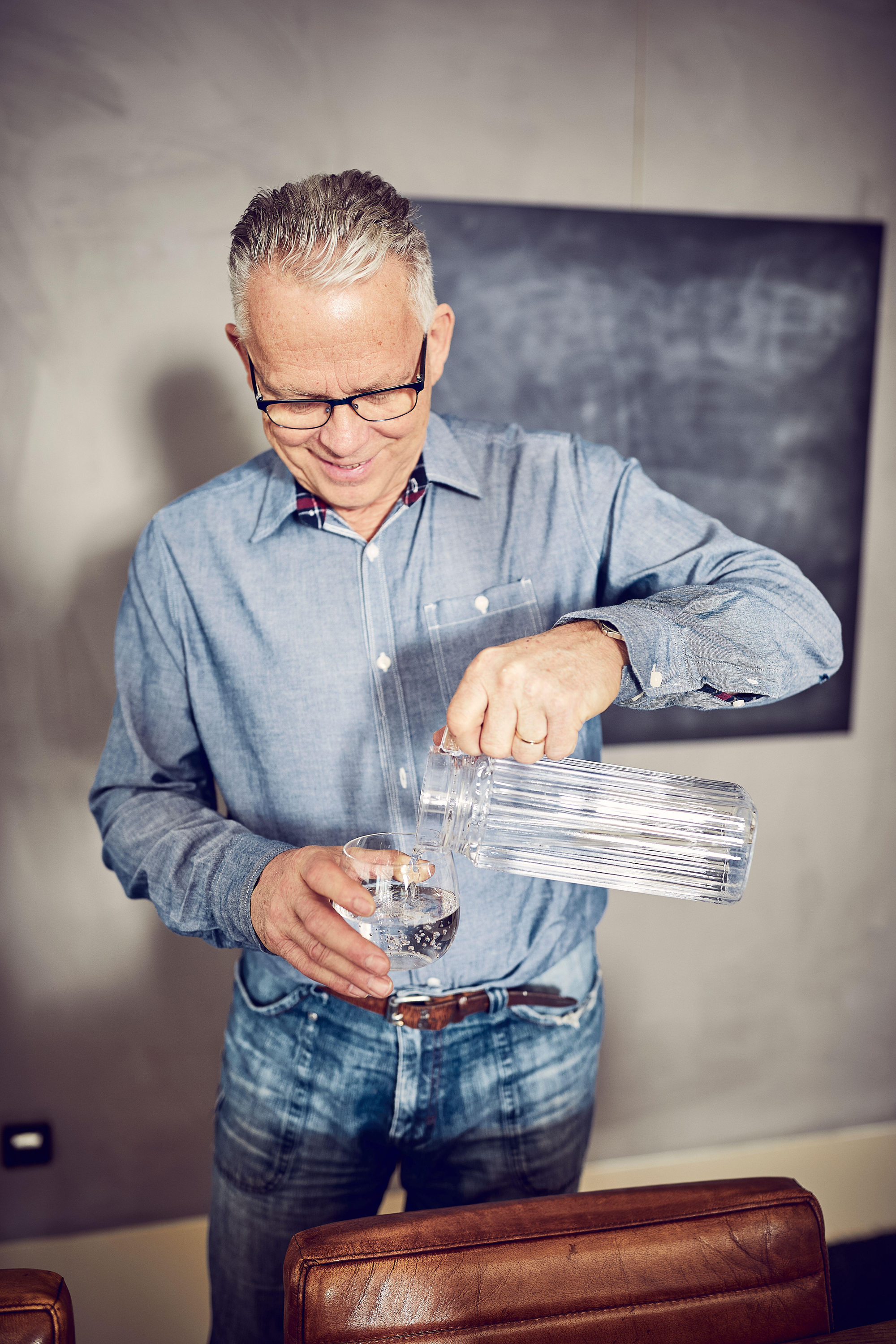 Man pouring water into glass