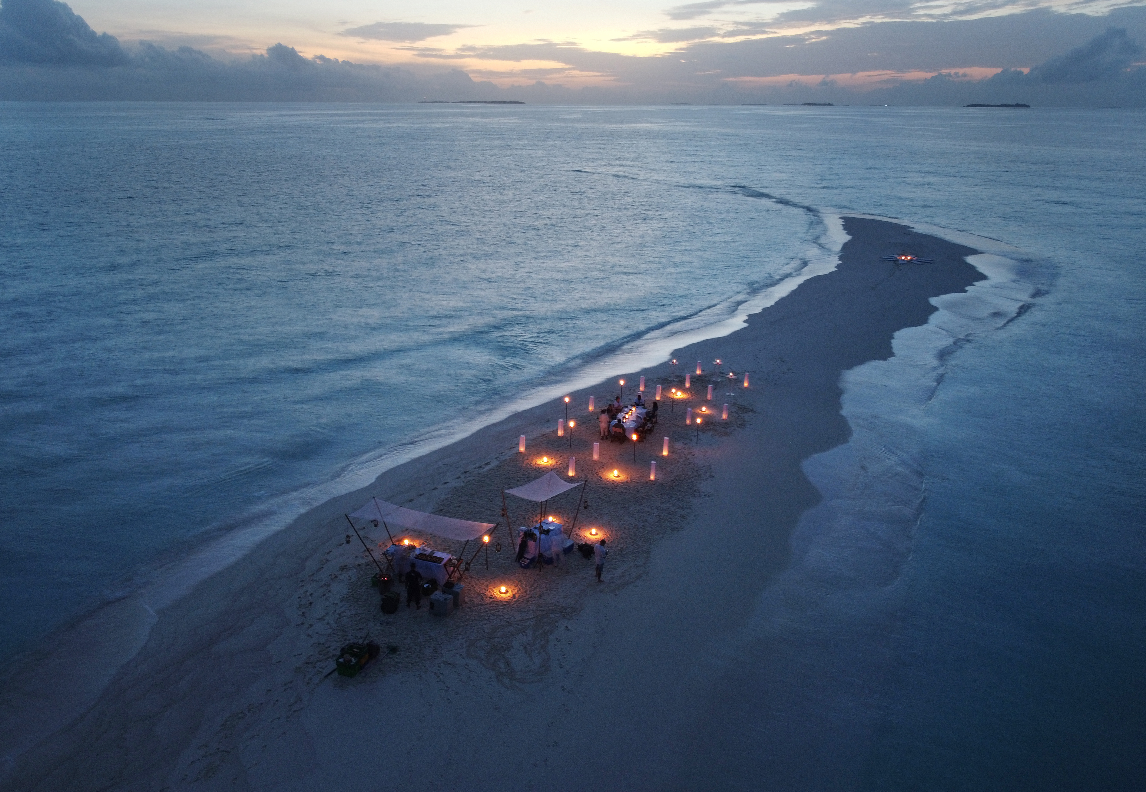 A private BBQ dinner set up on a secluded sandbank in the Indian Ocean as the sun sets (Owen Humphries/PA) 