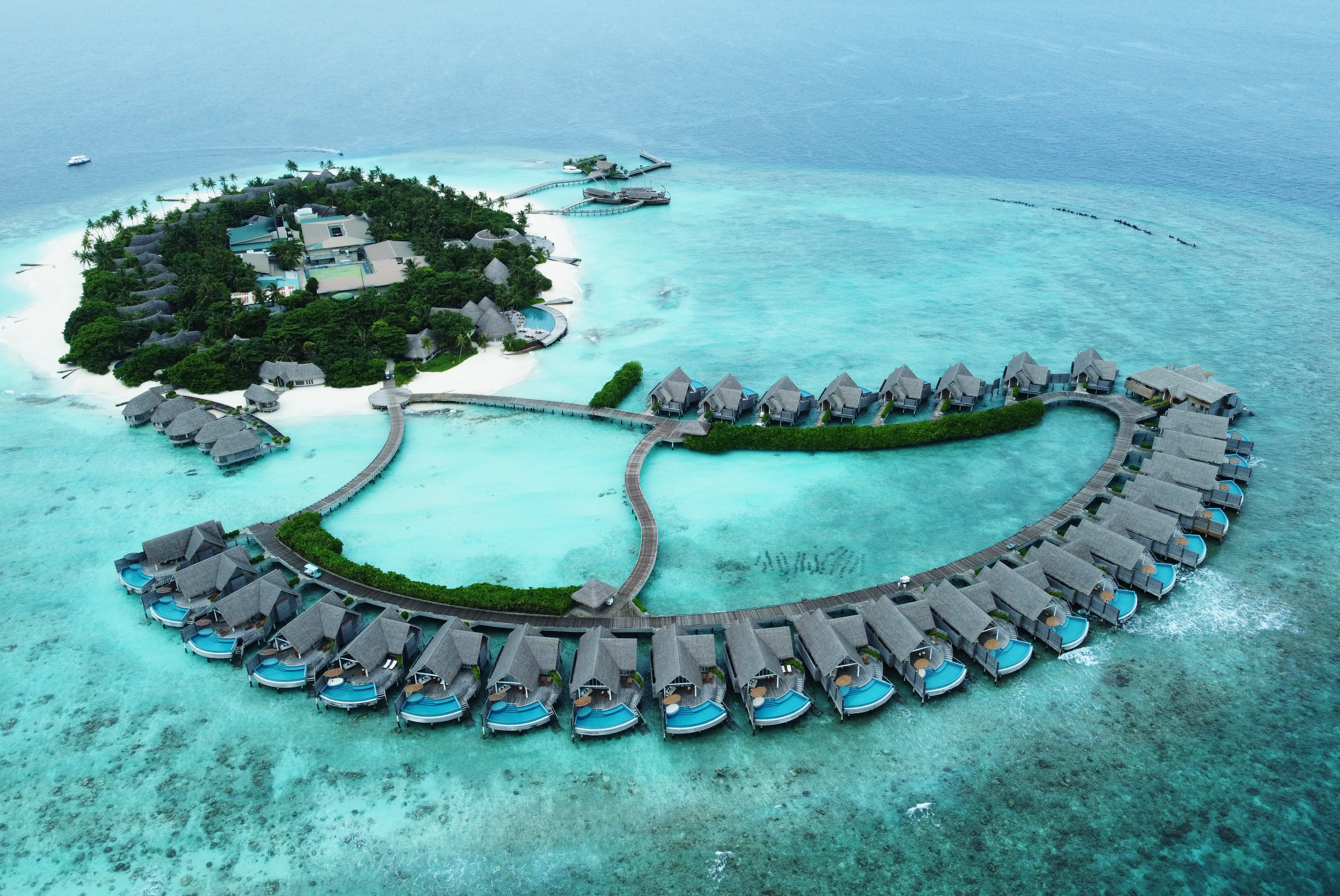 Milaidhoo island from above, with water villas in the foreground (Owen Humphries/PA) 