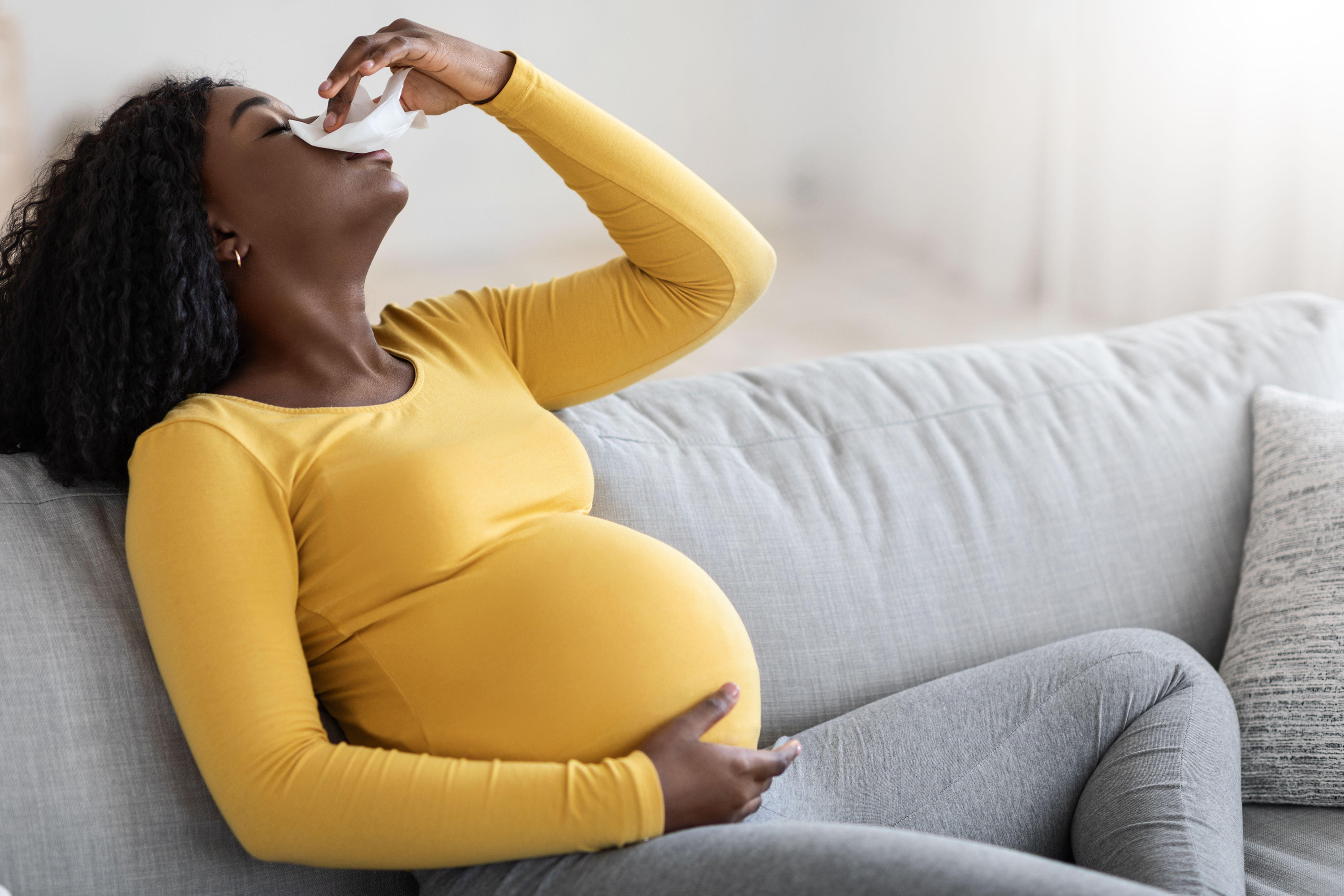 pregnant woman having a nosebleed