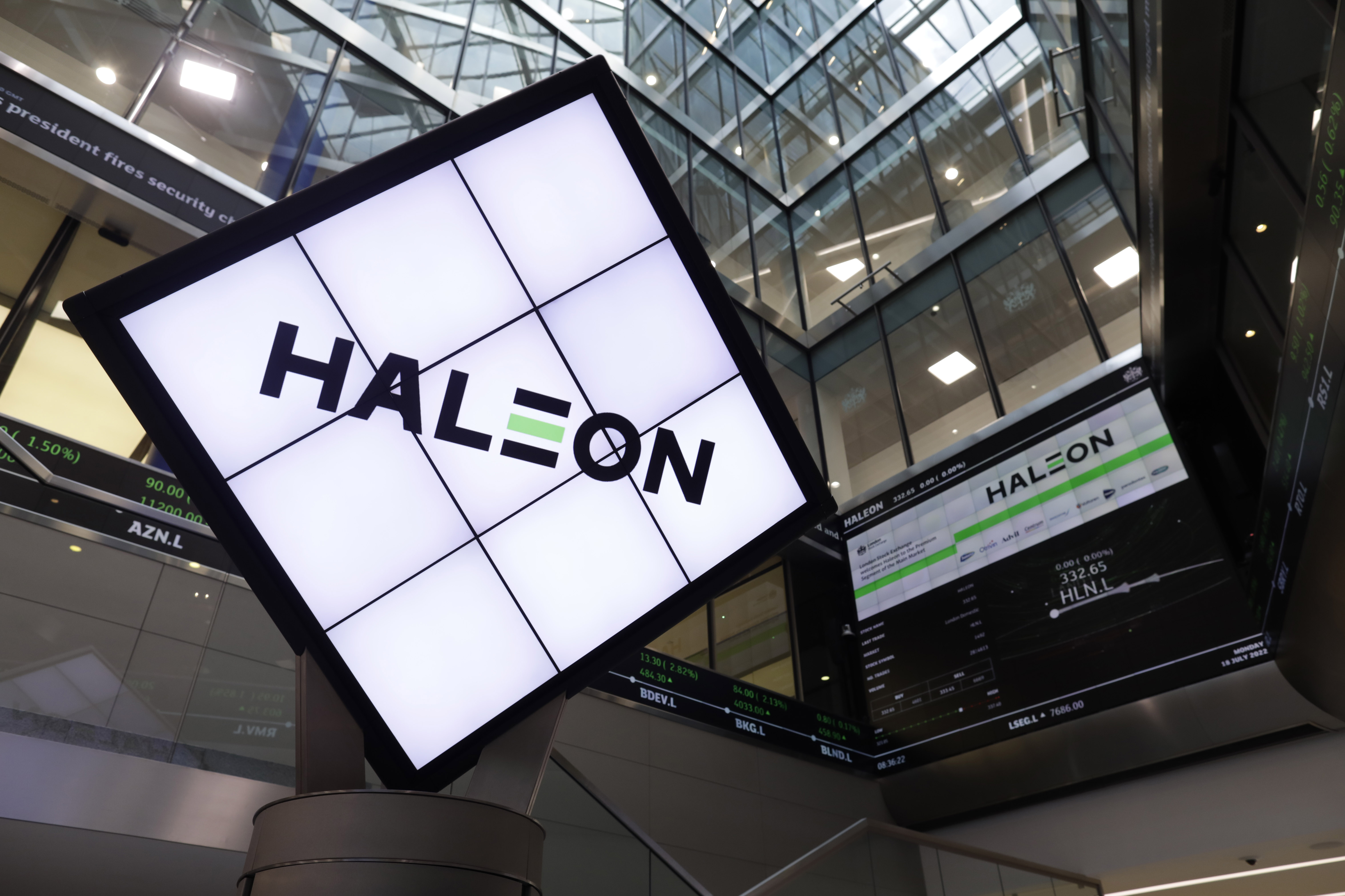 Illuminated Haleon sign next to listings screen