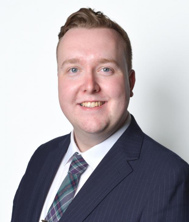 Handout head and shoulders portrait photo of Jordan Linden smiling