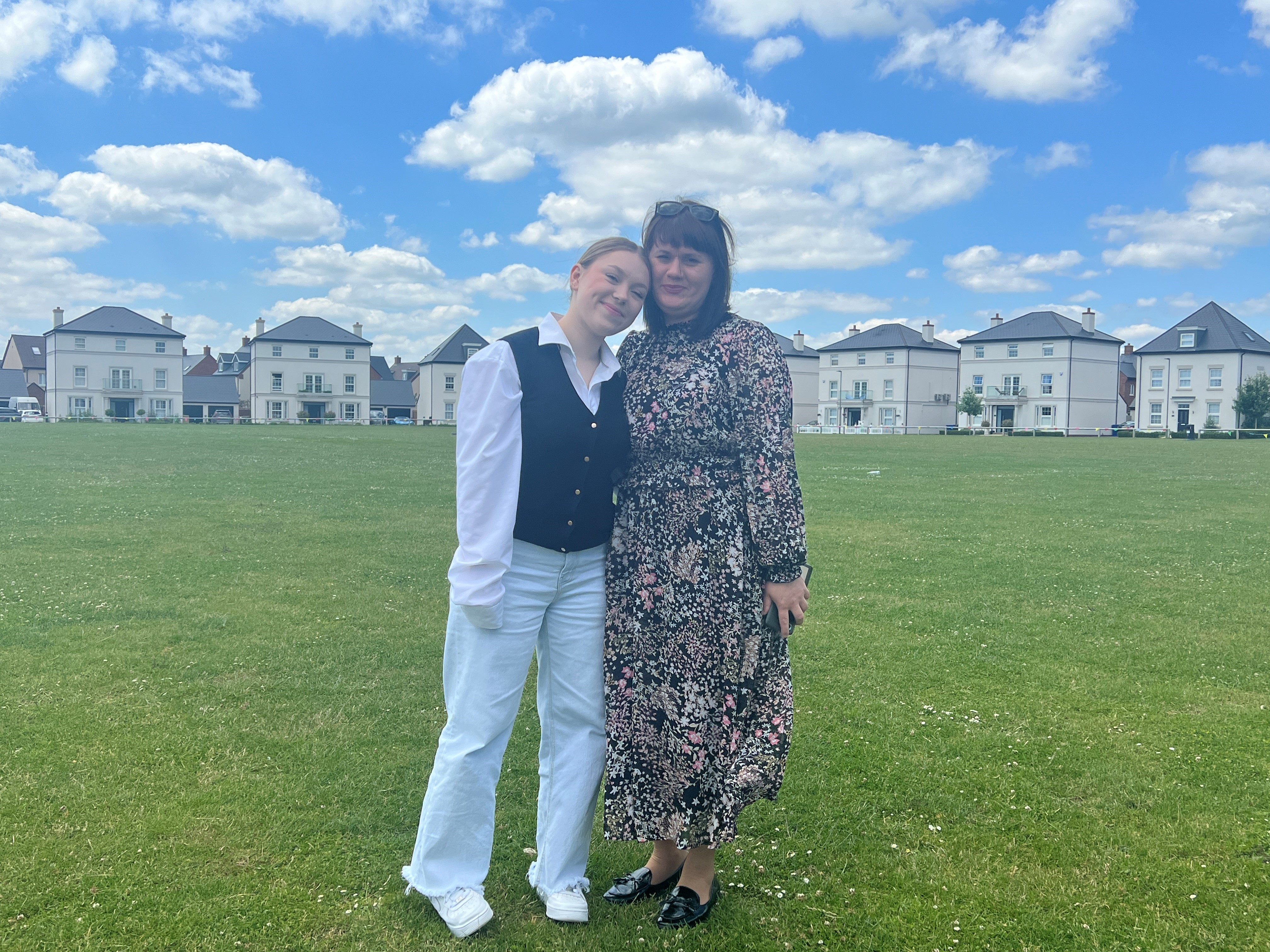 Two woman standing together and smiling