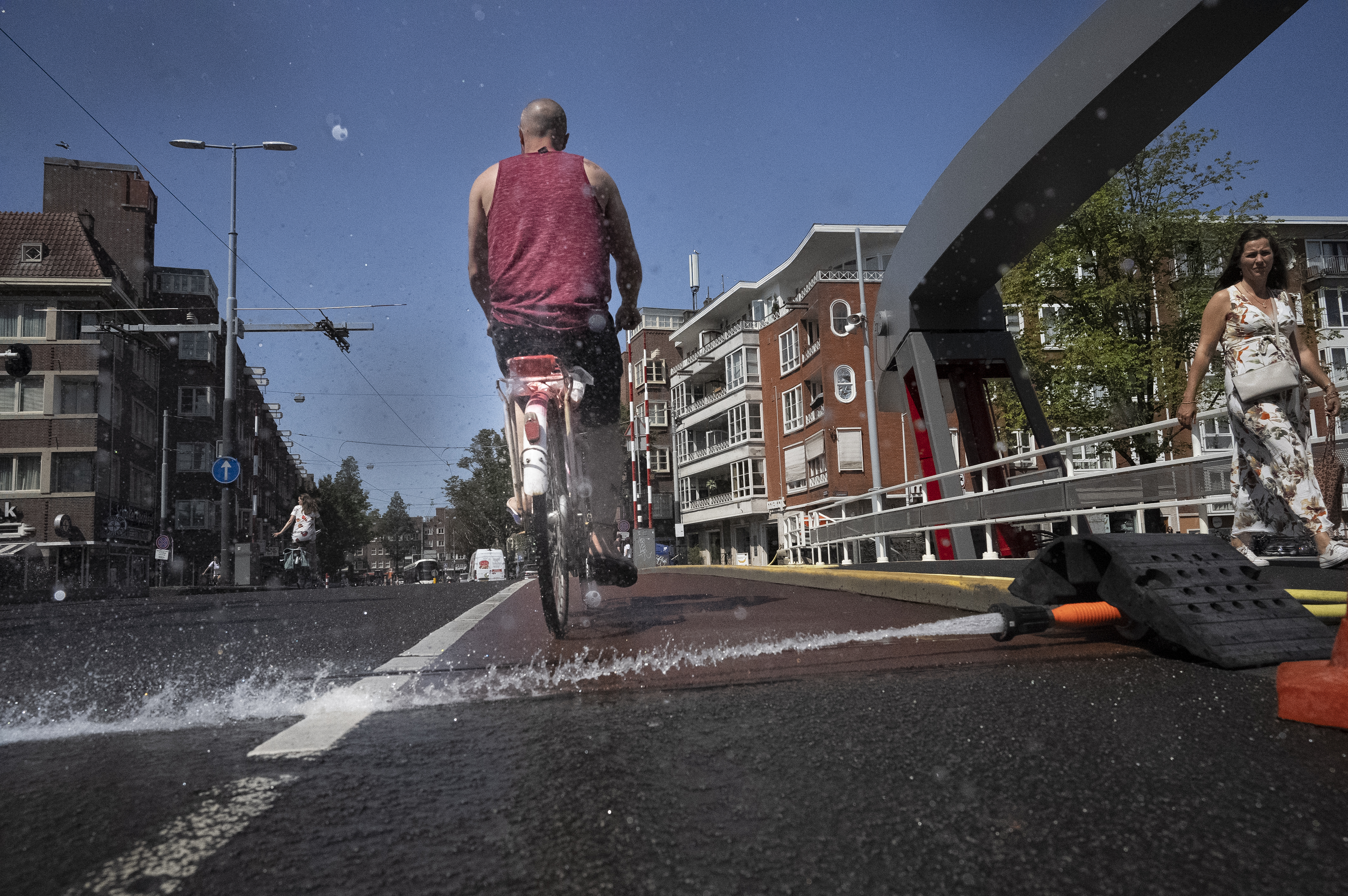 As the Dutch capital baked in the heat, municipal workers sprayed water on bridges over the city's canals to prevent metal in the constructions expanding which can jam them shut blocking boat traffic in Amsterdam