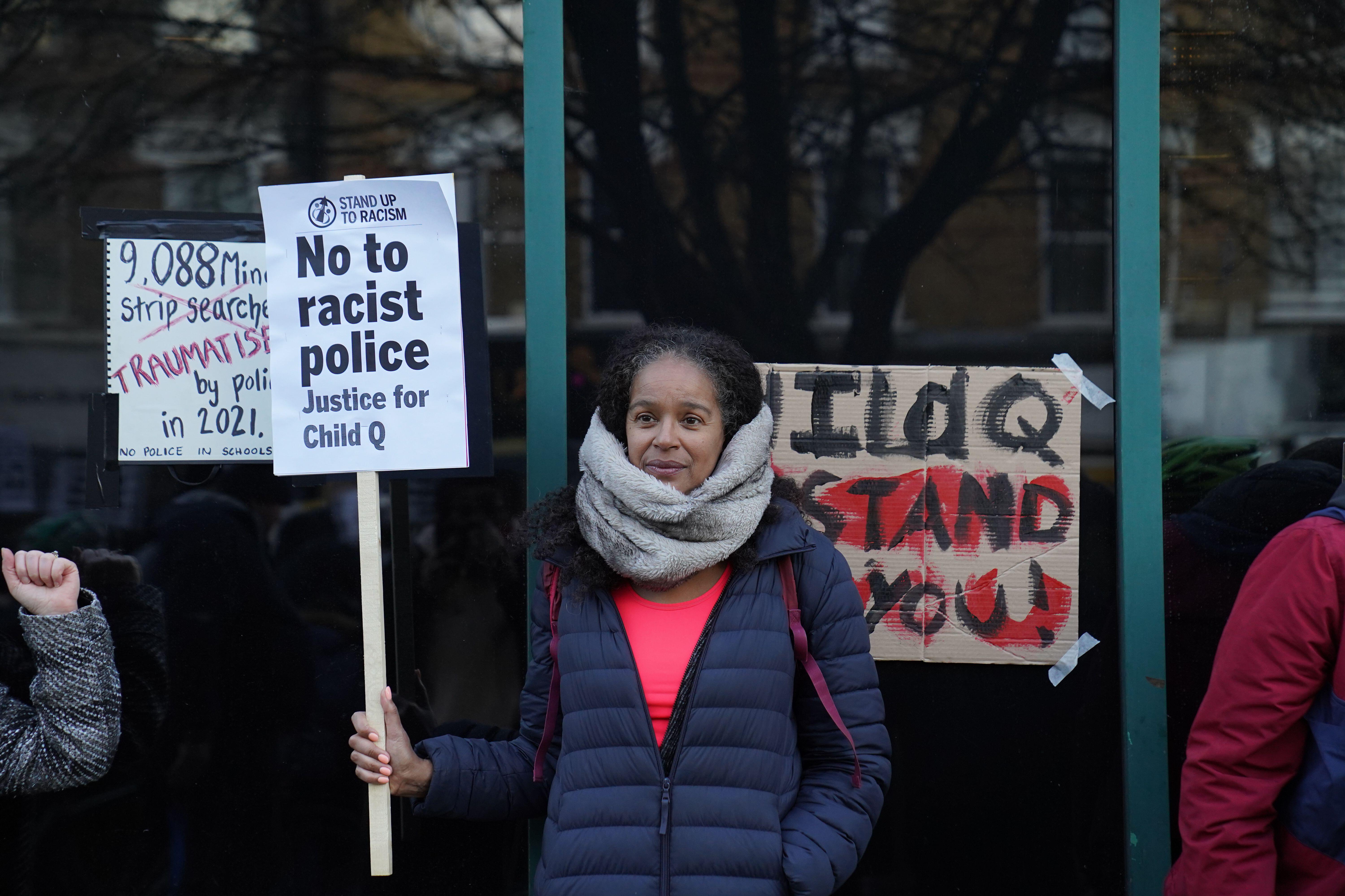 People demonstrate outside Stoke Newington Police Station in London, over the treatment of a black 15-year-old schoolgirl who was strip-searched by police while on her period