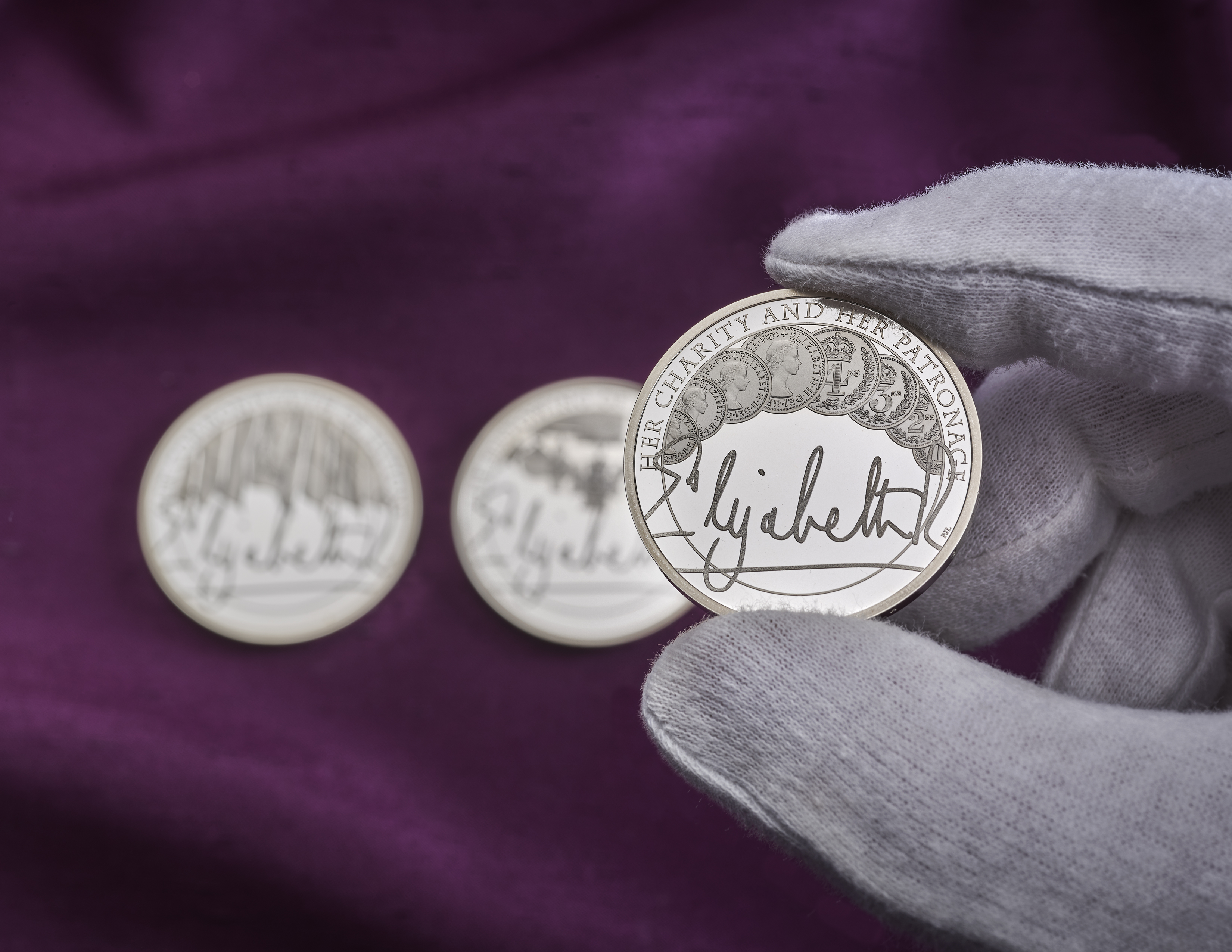 A Royal Mint coin being held