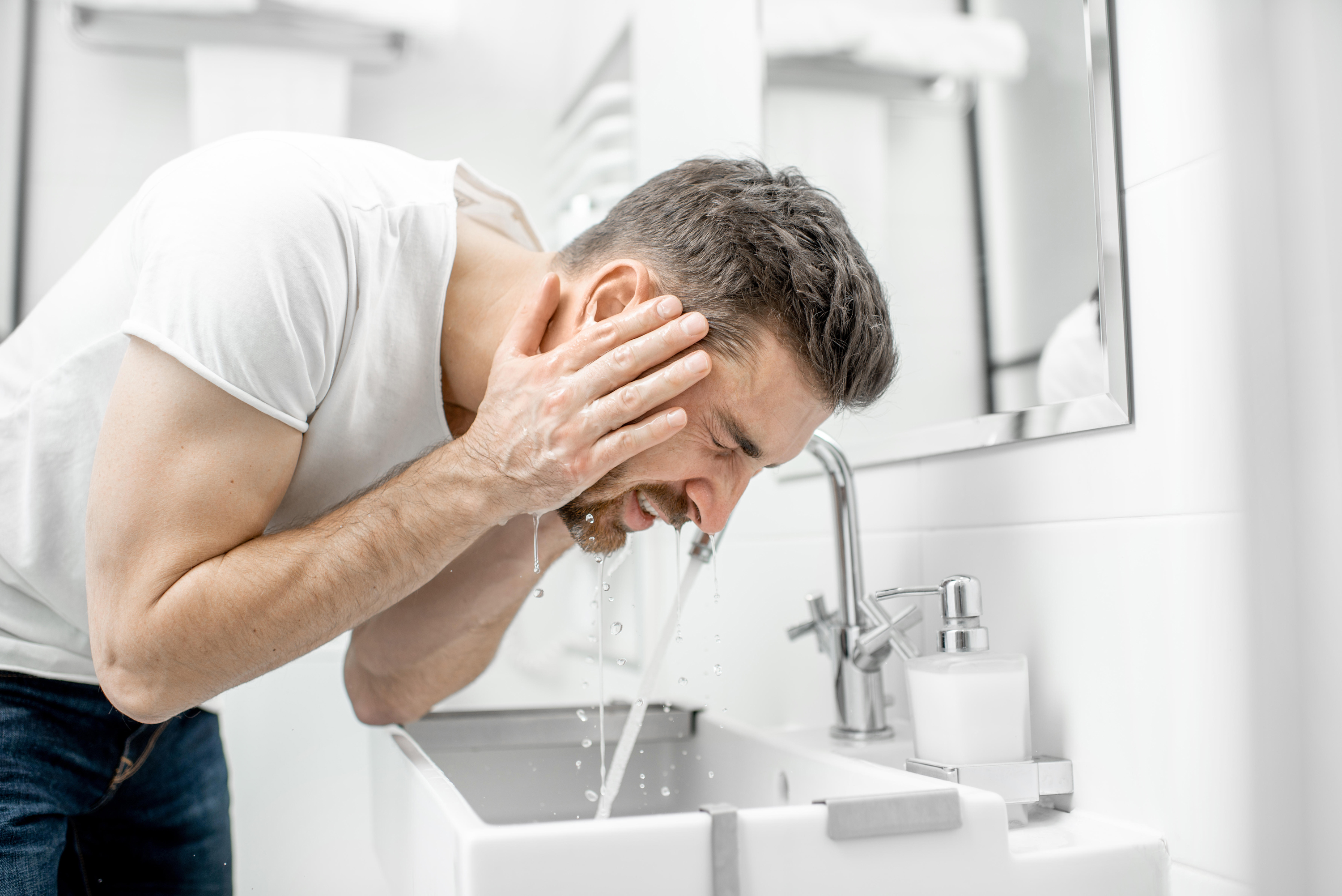 man washing face and beard