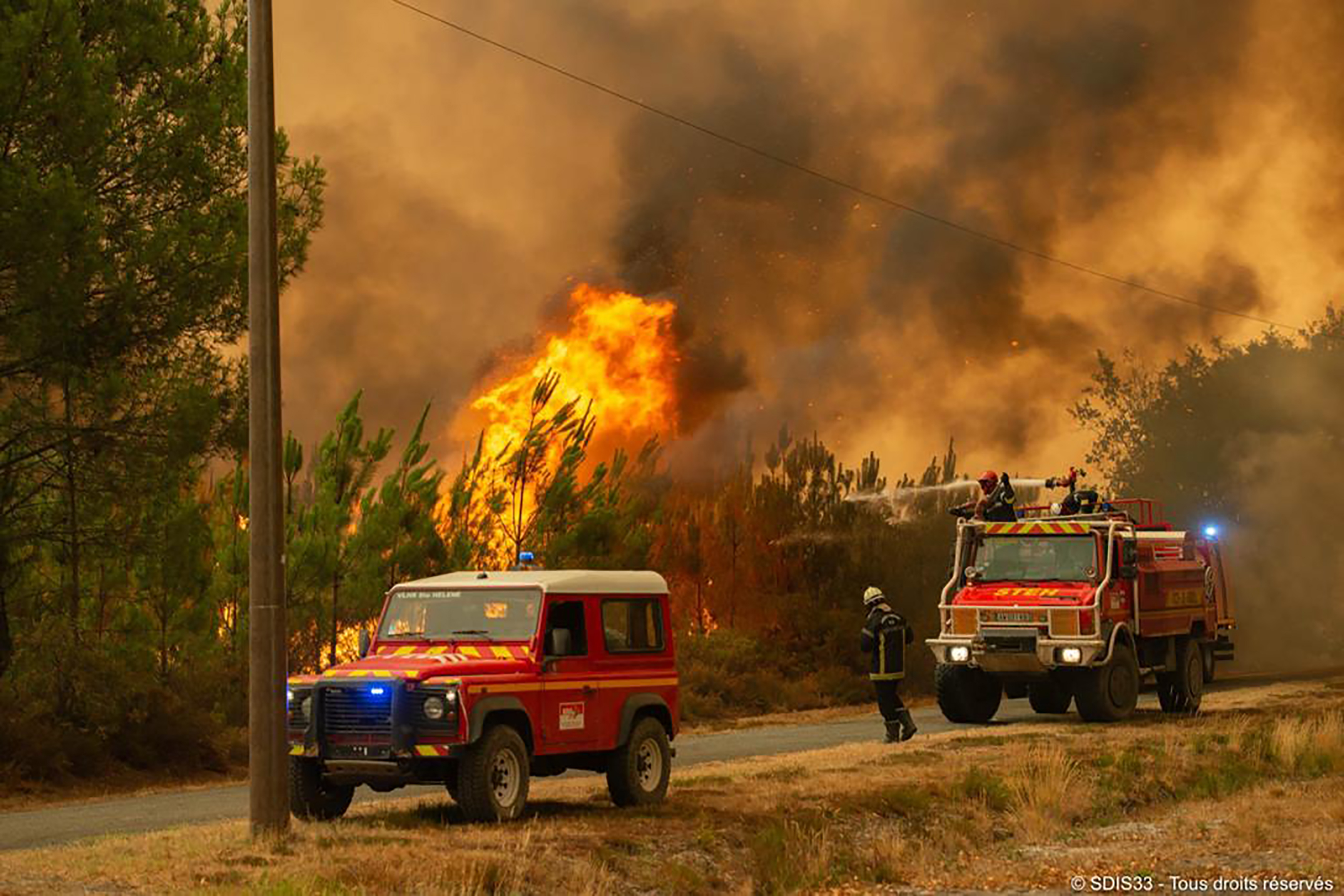 Firefighters tackling a blaze near Hostens, south of Bordeaux, southwestern France