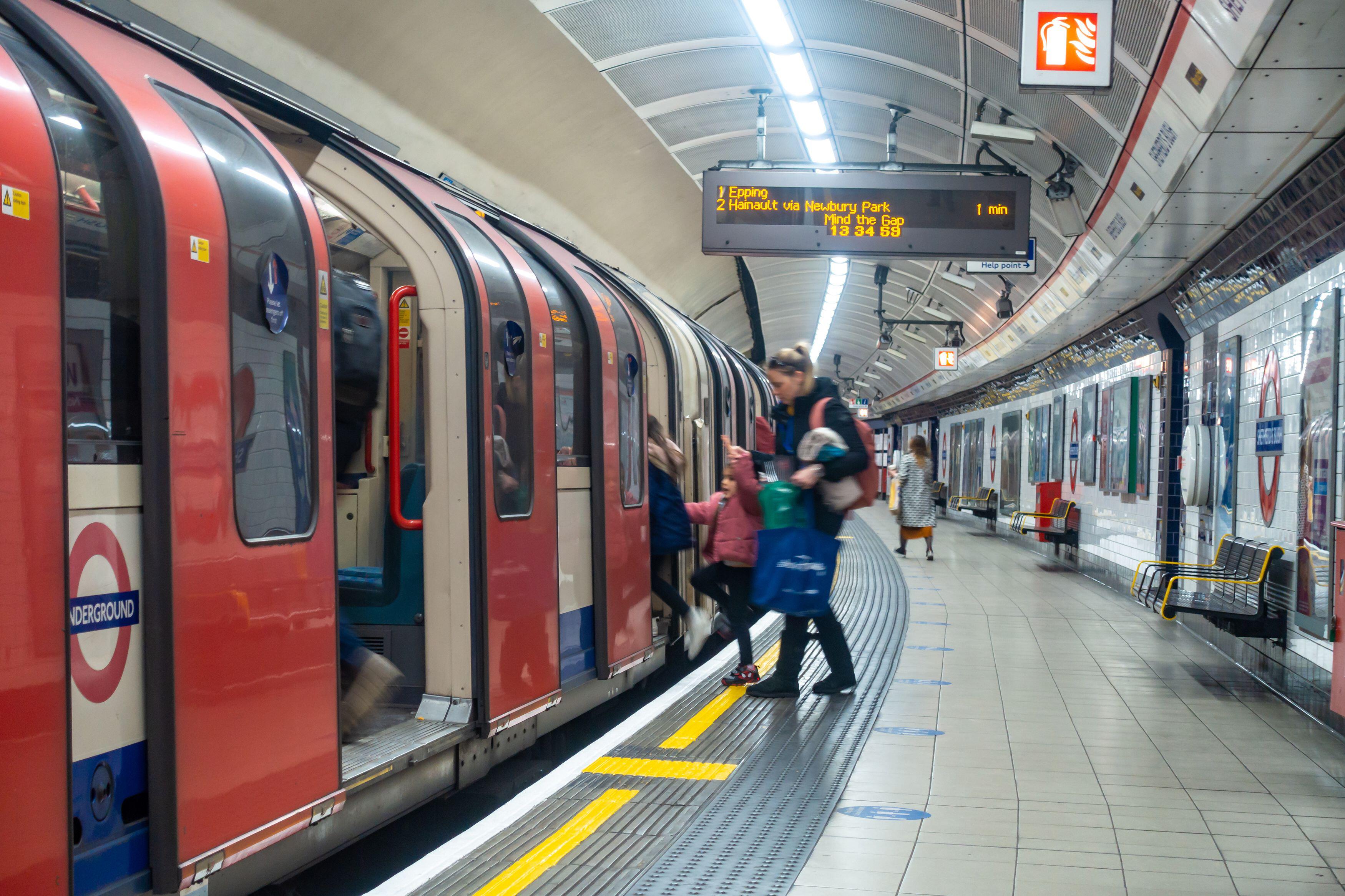 Passengers board a London Underground train at Shepherd's Bush station on the Central Line