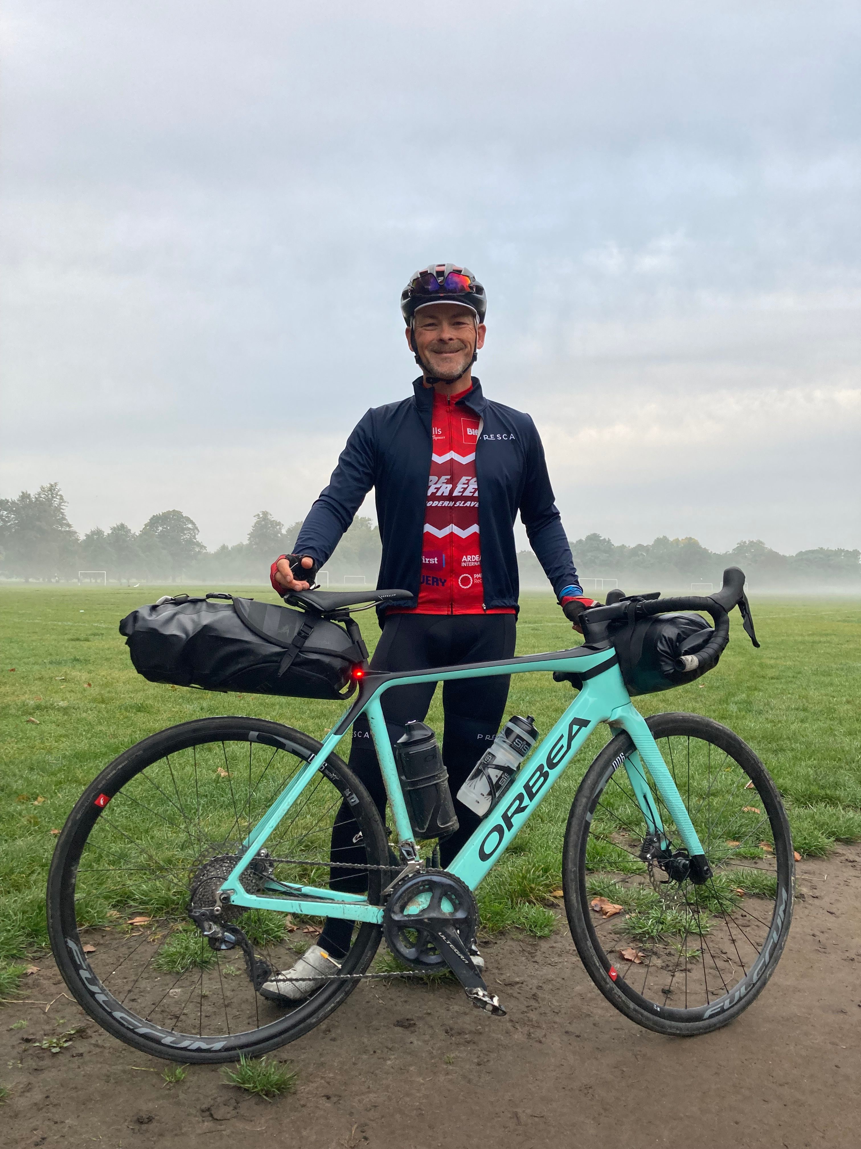 Man standing next to bike