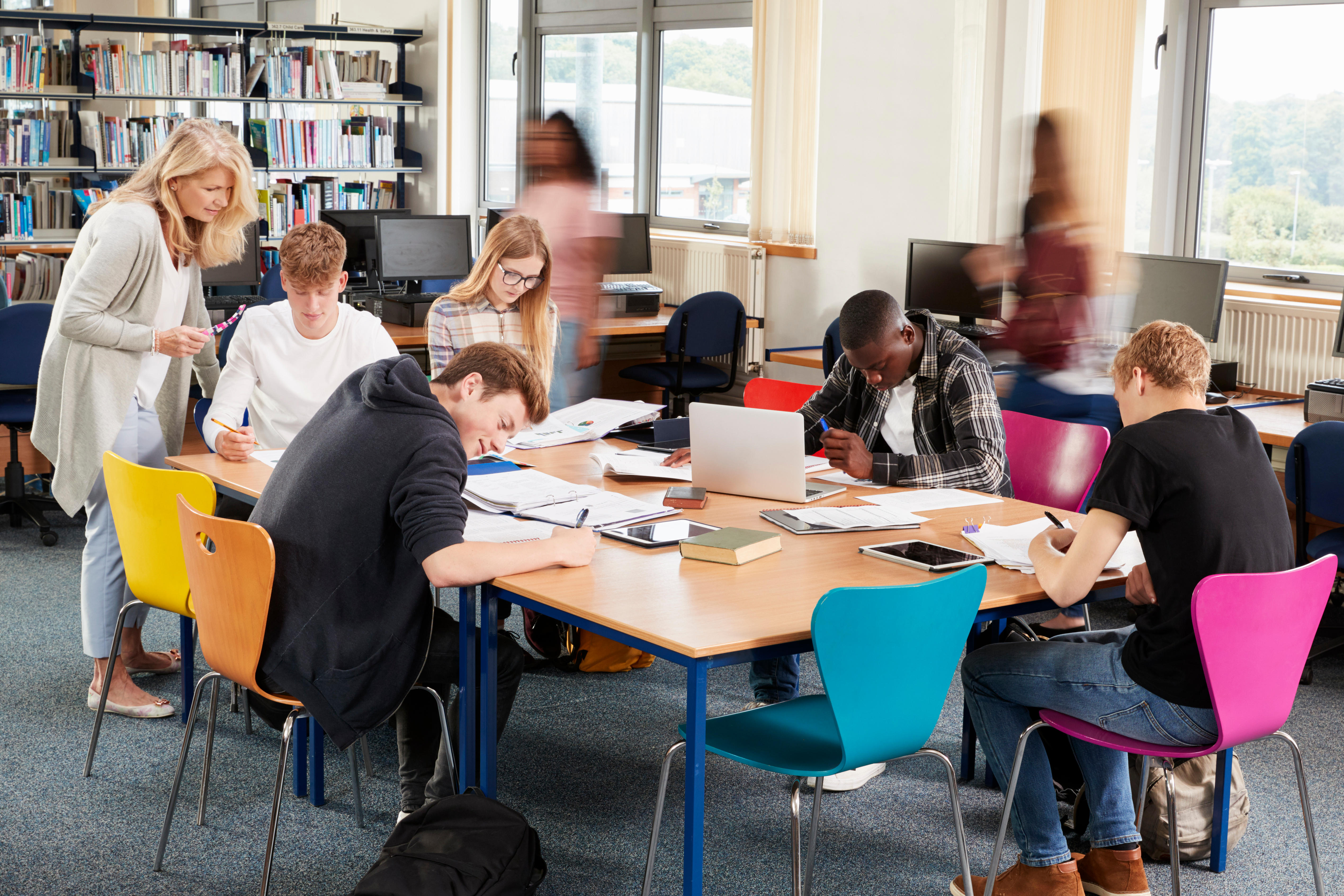 Students sat around a library table