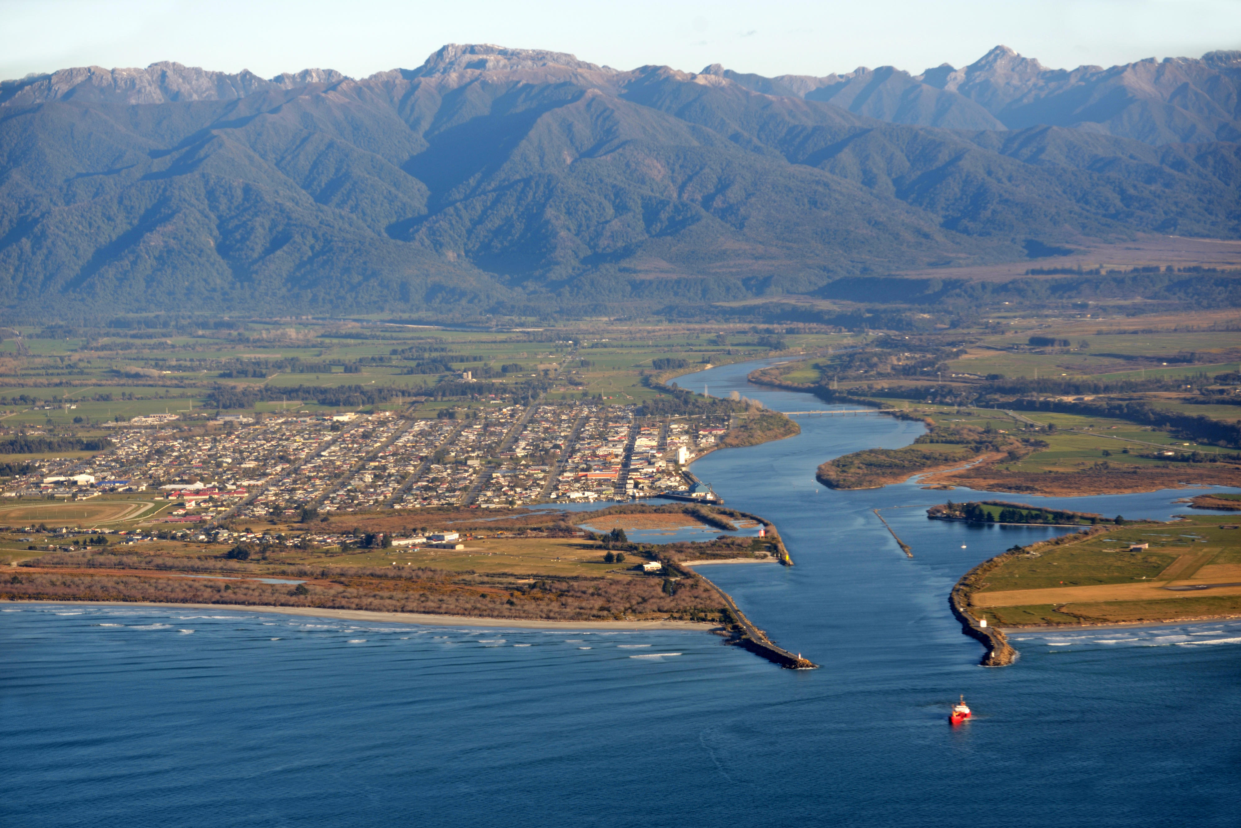 The Buller River dredge at work on a sunny day in Westport, New Zealand