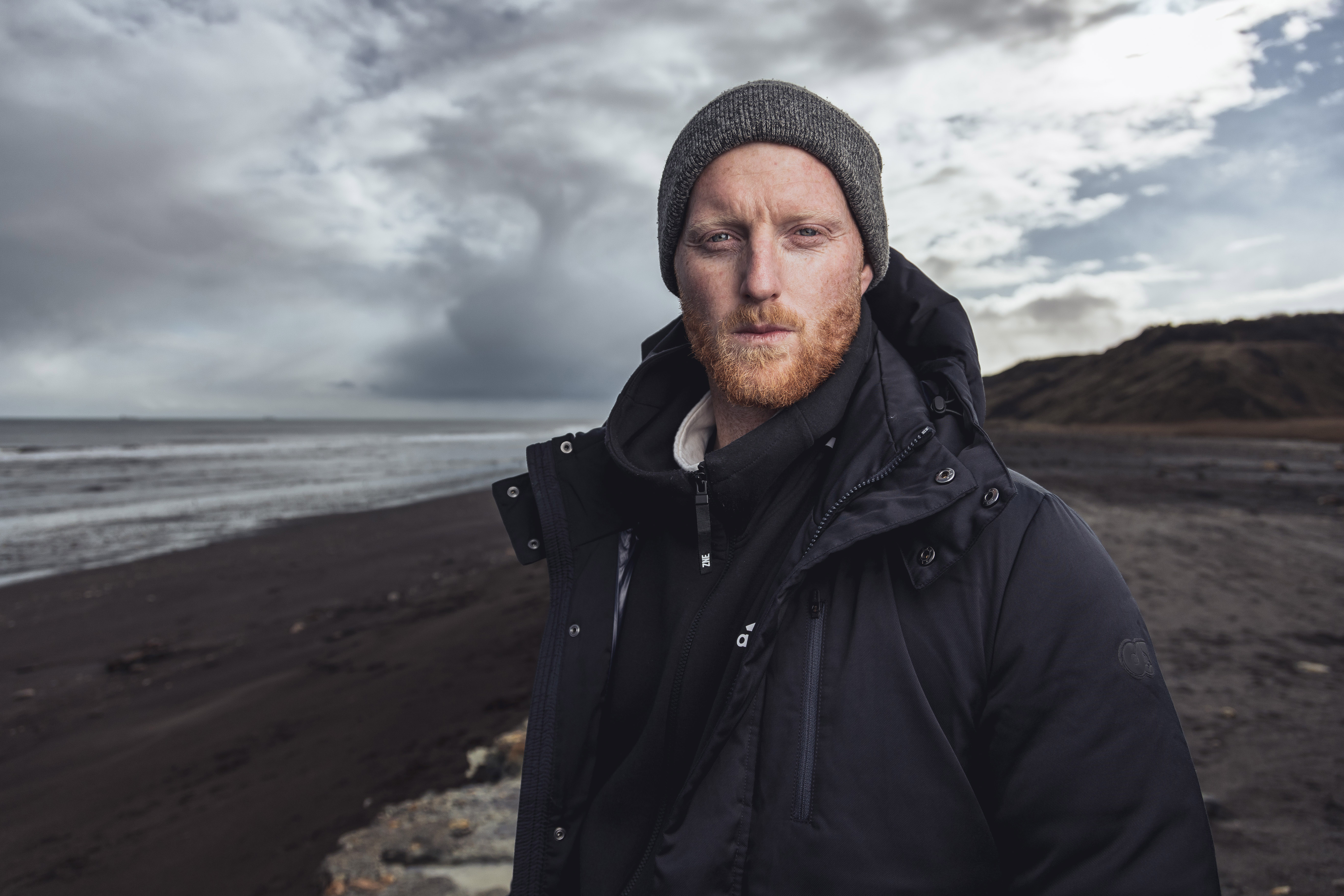 Ben Stokes standing on a beach