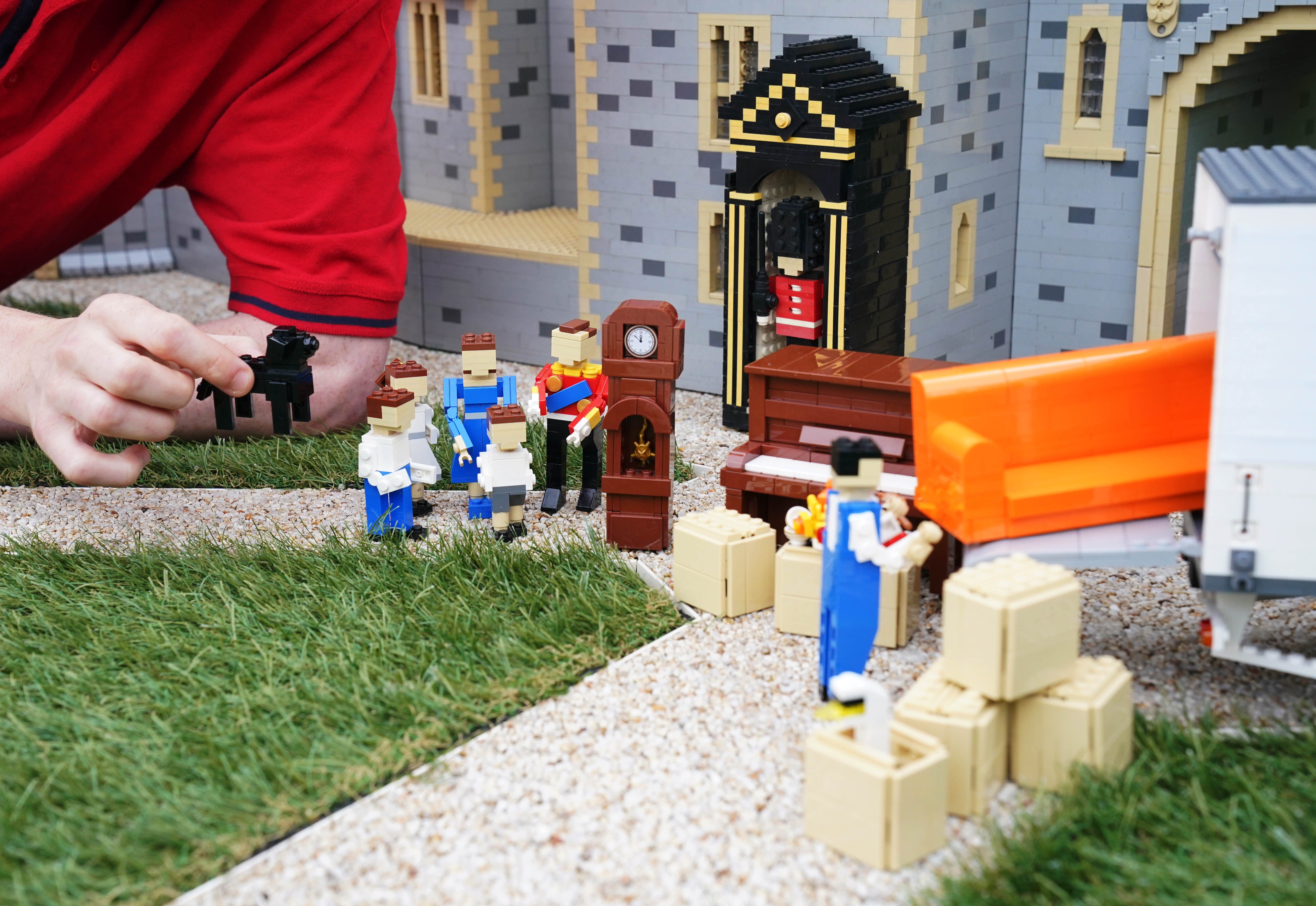 Legoland Windsor Resort Model Maker Will Metcalfe finalises the display of Lego figures of the Duke and Duchess of Cambridge