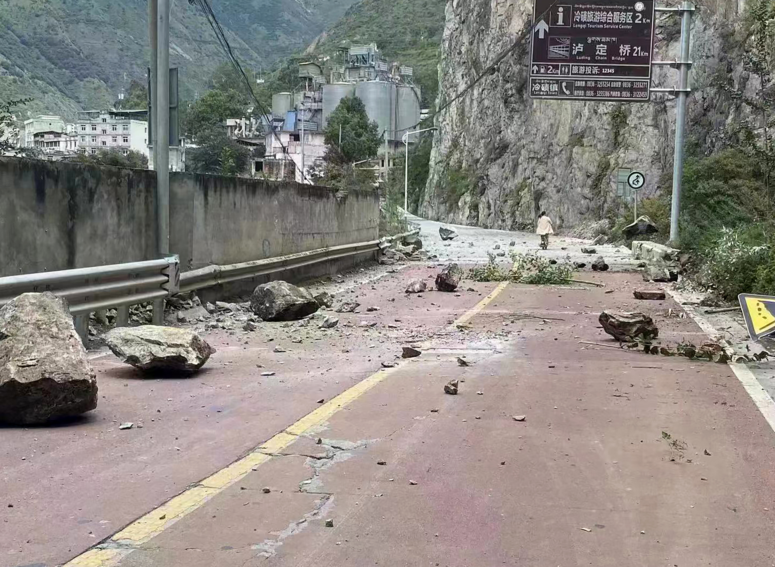 Fallen rocks are seen on a road near Lengqi Town in Luding County 