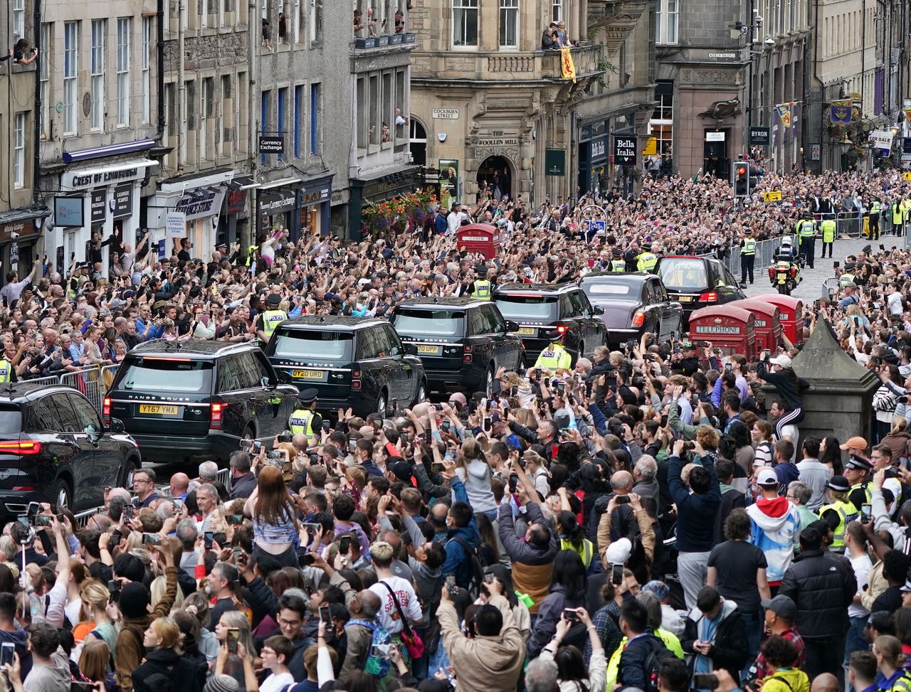 Applause from packed crowds as Queen’s cortege made its way down the